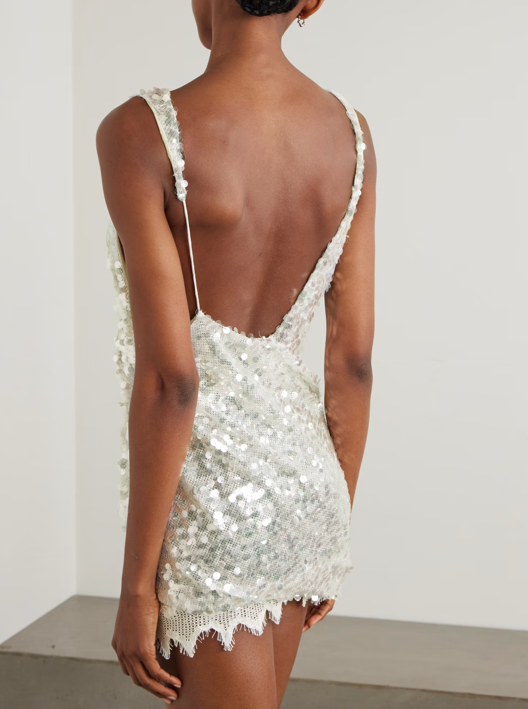 This Cotton-blend Lace-trimmed Sequined Mesh Mini Dress by Christopher Esber brings effortless glamour to your party lineup. Crafted from shimmering mesh adorned with opaline sequins, it catches the light beautifully, while the jagged lace hem and asymmetric neckline add a modern, distinctive touch. Perfect for standing out, pair it with heeled sandals and shimmery eye shadow to complete your unforgettable look.