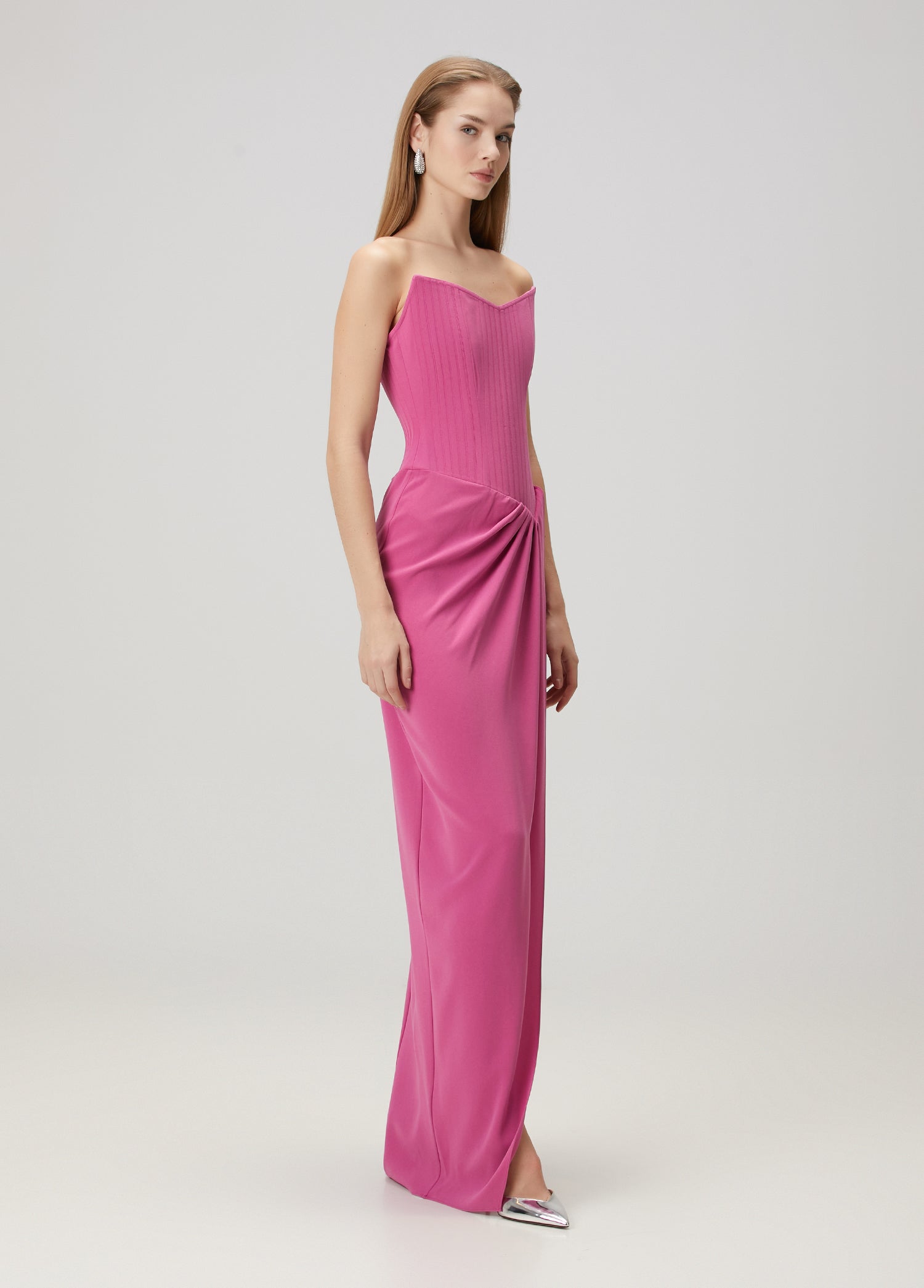 Elevate your evening look with this stunning pink maxi dress by Alex Perry that combines timeless elegance with modern sophistication. The strapless design creates a graceful silhouette, while expertly placed drapes add dimension and movement to every step. A daring thigh-high slit offers a hint of allure without compromising the dress's refined aesthetic. The secure back zipper ensures a flawless fit that lasts all night. 