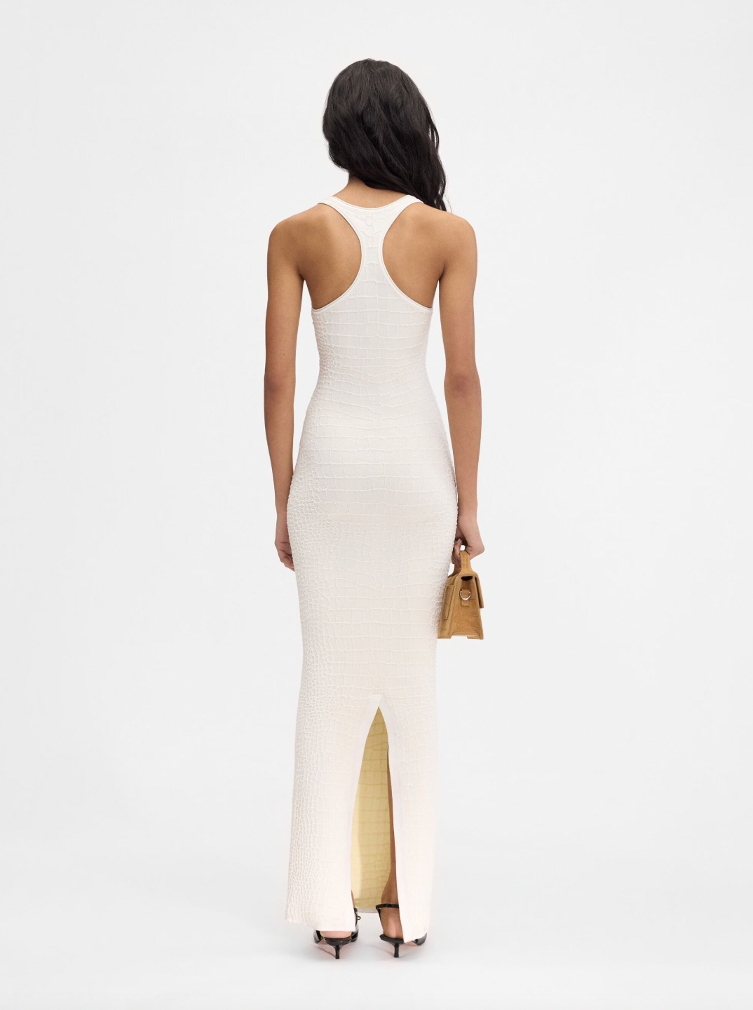 The Scala dress by Jacquemus combines elegance and edge with its long, fitted silhouette crafted from crocodile-embossed stretch viscose. Its square neckline and sleeveless racerback design enhance your natural shape while offering comfort and style. A long back slit adds a daring touch, and the subtle “J” locker loop detail sets this dress apart. Perfect for making a bold statement at any event.