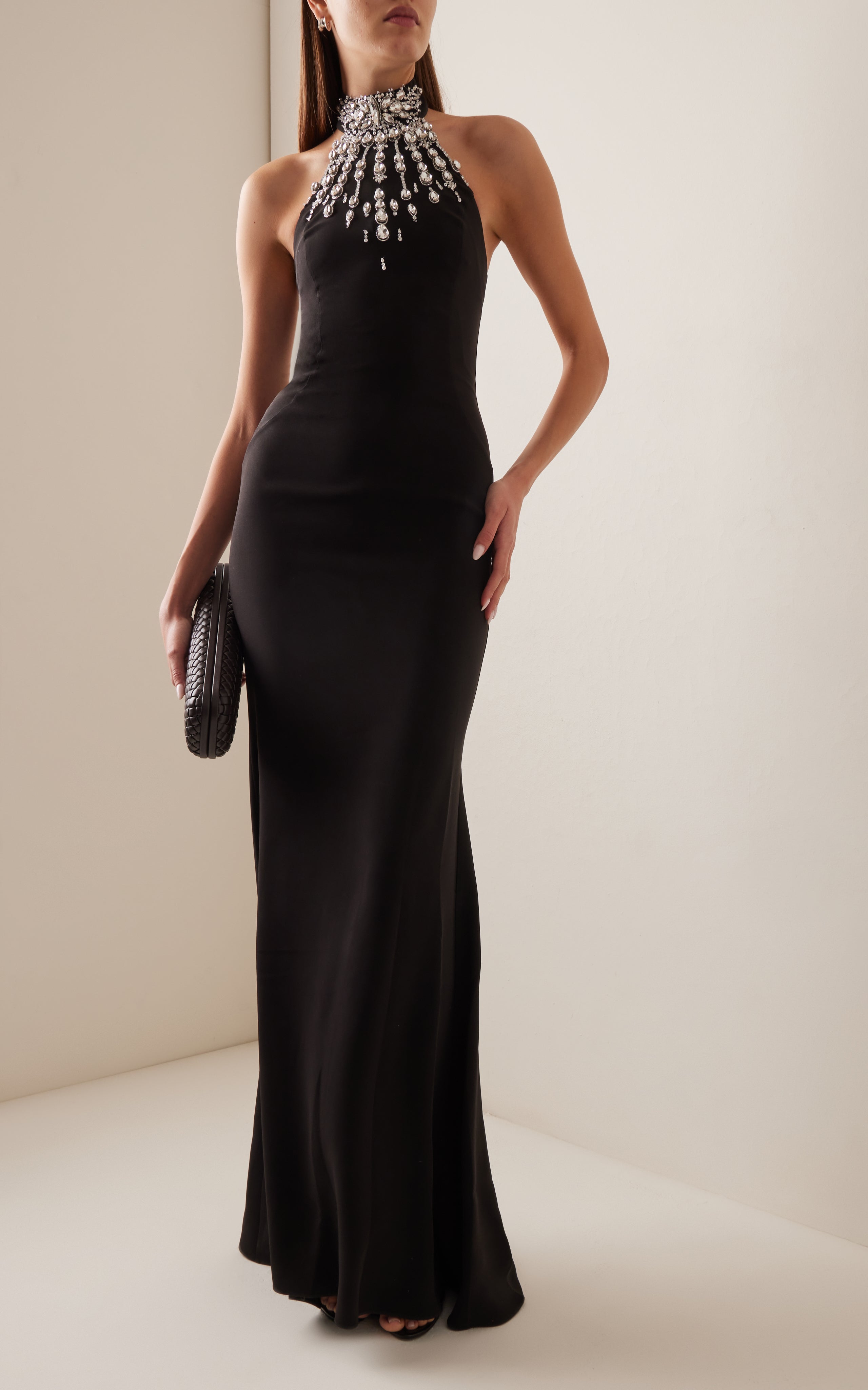 Make a statement in the Crystal-Embellished Cady Halter Maxi Dress by Zuhair Murad! Crafted from luxurious cady fabric, this halter gown boasts a slim, figure-flattering silhouette. The beautiful teardrop crystal embellishments add a touch of elegance and glamour to any evening occasion. Complete the look with a stunning crystal clutch for a truly showstopping ensemble.