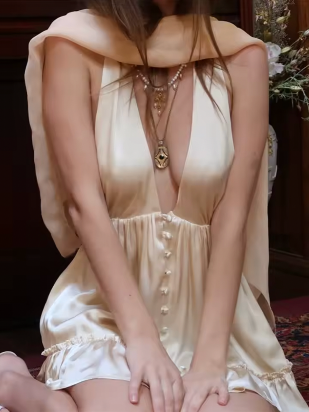 Experience elegance with the Caroline Silk Dress by Fait par Foutch. Made from medium-weight 100% silk charmeuse, this dress offers a smooth, luxurious feel and graceful drape. Fully lined with pure silk, it ensures all-day comfort. Functional silk-covered buttons adorn the front, while the adjustable halter straps tie into a bow for a perfect fit. The low V-neck and back, combined with hidden elastic at the waist, create a flattering silhouette that moves with you. 