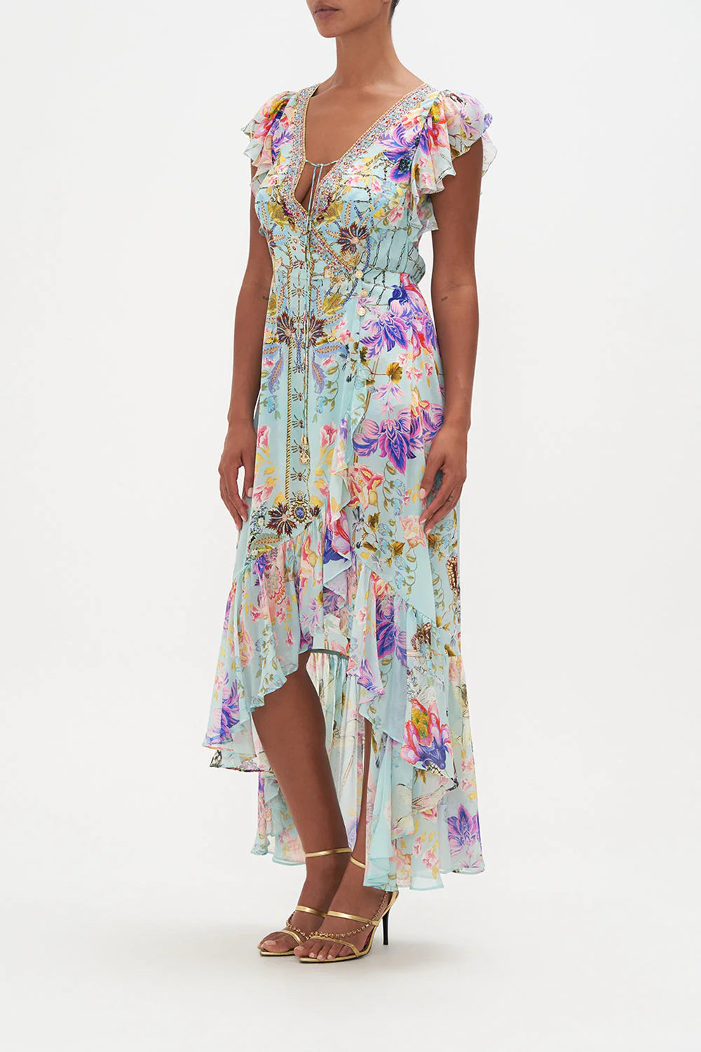 Indulge in elegance with our Love Web Ruffle Wrap Dress by Camilla, inspired by the artistry and femininity. Handcrafted from luxurious silk, this dress features a high-low ruffle hemline and waist-cinching wrap silhouette. Complete with crystal embellishments and neck ties.