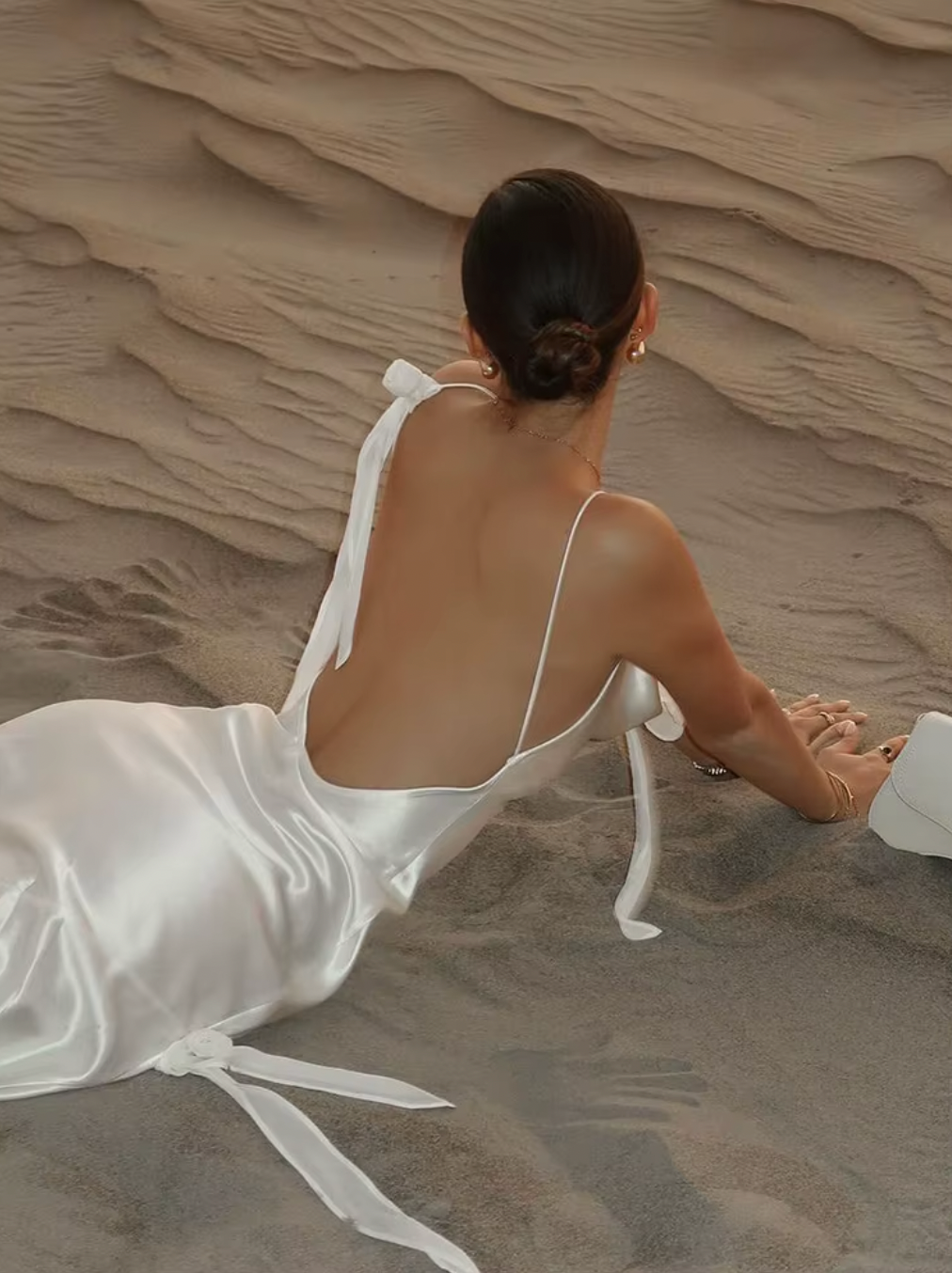 Indulge in effortless elegance with the Lorella Maxi Dress. The lustrous satin fabric is cut on a bias for a flattering fit, while the cowl neck, chic shoulder detail, and deep back drape add a touch of sophistication. The straps can be tailored for a perfect fit, making it the ideal choice for any event.