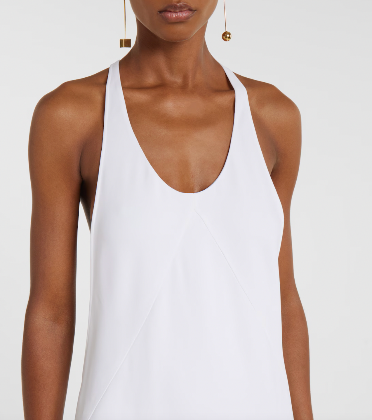 Experience timeless elegance with this Jacquemus-inspired knitted gown. Crafted in a crisp white hue, its minimalist design features a sleeveless silhouette and a graceful scoop neckline, creating a refined and effortlessly sophisticated look that flows beautifully to the floor. Perfect for those seeking understated luxury with a modern touch.