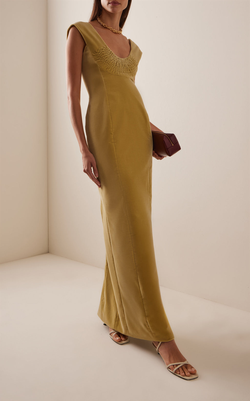 Luxurious cotton-velvet construction wraps your silhouette in sumptuous comfort, while the scooped bodice flatters with understated elegance. The flowing column skirt features a thigh-high split that moves with you, balancing sophistication with modern allure. Perfect for evening events or upscale occasions, this dress transitions effortlessly from dinner to dancing. Pair with leather pumps and delicate jewelry to complete the refined look.