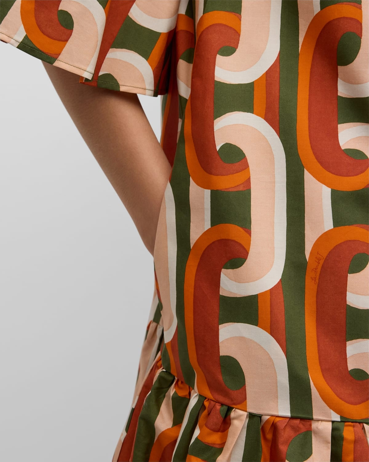 Elevate your everyday wardrobe with the DoubleJ Choux shirtdress, a sophisticated Italian-crafted piece that effortlessly transitions from day to night. This cotton mini dress features an eye-catching chain-link print and charming tiered ruffle hem that adds movement and dimension. The classic point collar and button-front design offer timeless appeal, while practical side split pockets keep essentials within reach. 