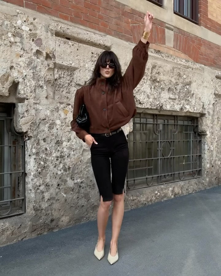 This Ruched Suede Jacket in Brown blends timeless style with contemporary flair. Featuring a boxy silhouette and padded shoulders, it exudes confidence, while the stand collar and gathered pleats add refined detail. The softly structured waistband creates a relaxed blouson effect, offering a polished look that’s both comfortable and stylish. Fully lined for all-day ease, this jacket effortlessly enhances any outfit with understated sophistication.