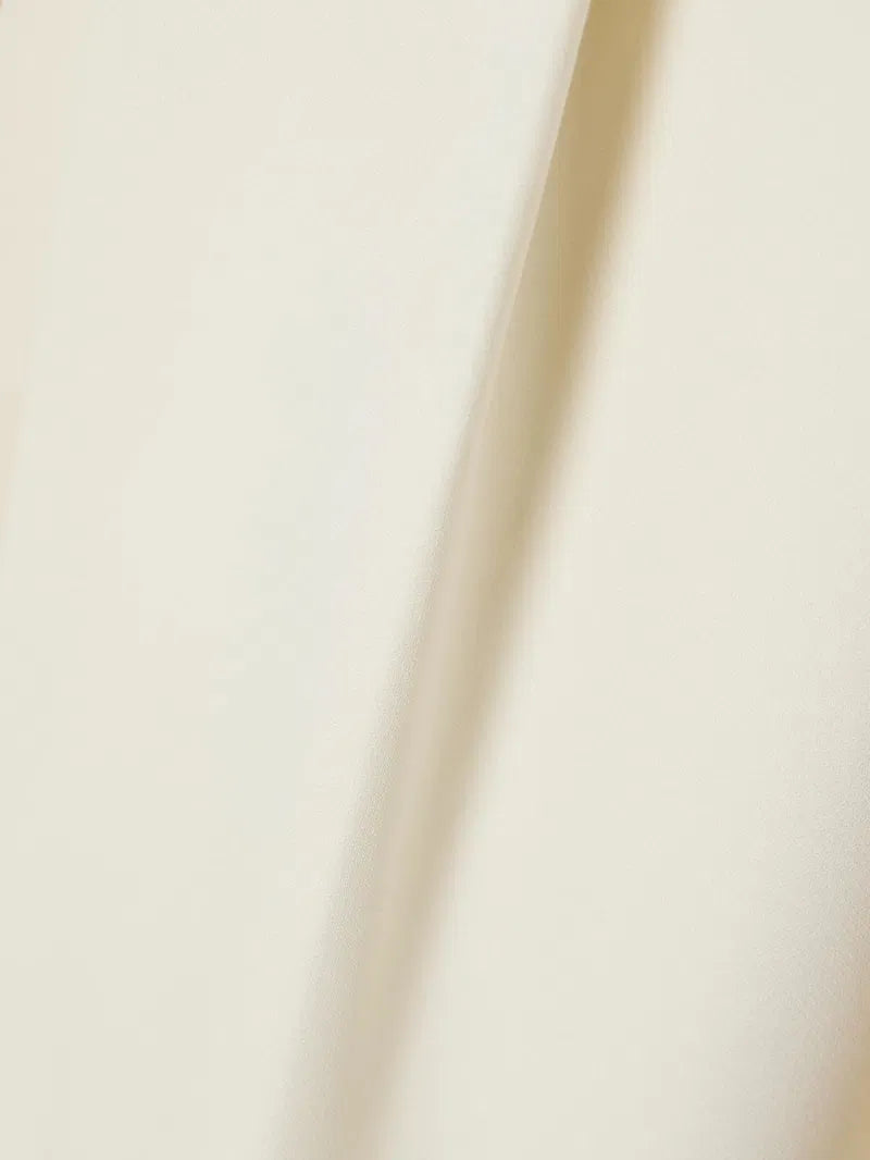 This versatile midi skirt combines timeless elegance with everyday wearability. Crafted from a luxurious wool and silk blend, it features deep pleats that create beautiful movement and dimension with every step. The refined design pairs effortlessly with knee boots, mules, or your favorite footwear, making it a wardrobe essential that transitions seamlessly from season to season. Invest in a piece that works as hard as you do.