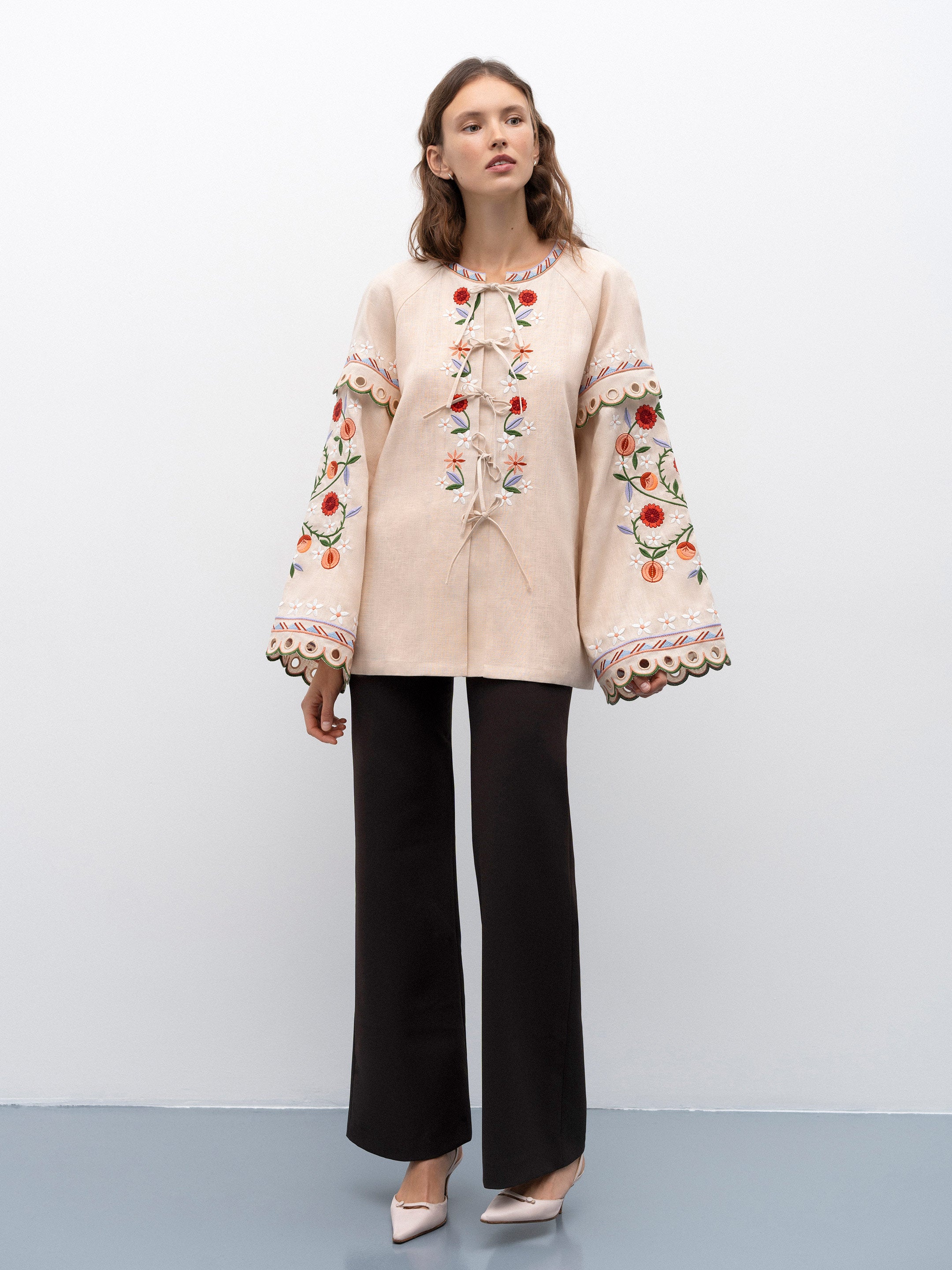 Get ready to turn heads with the Leena Embroidered Blouse! This stylish blouse features a beautiful 3D flower embroidery, flared sleeves, and a chic lace-up neckline. Embrace your unique fashion sense with this vintage-inspired piece.