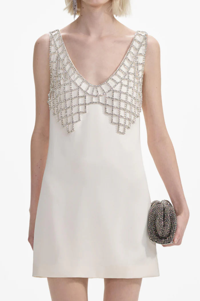 Indulge in after dark adventures with this cream satin mini dress by Self-portrait. The fitted style creates a sultry silhouette, while the removable diamanté bralette adds daring detail. Featuring a deep 'U' neckline and zip closure at the back, this dress is designed for a head-turning entrance.