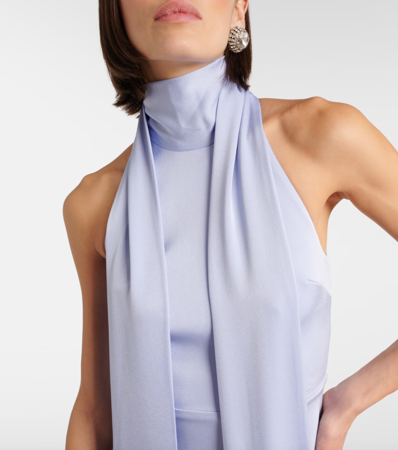 Elevate your elegance with the Scarf-detail halterneck satin gown by Alex Perry. Designed for comfort and sophistication, this gown’s smooth satin fabric and unique halter neckline with a graceful scarf detail create a striking silhouette. Ideal for formal occasions, it promises to make you stand out confidently, especially when paired with statement earrings and an elegant updo.