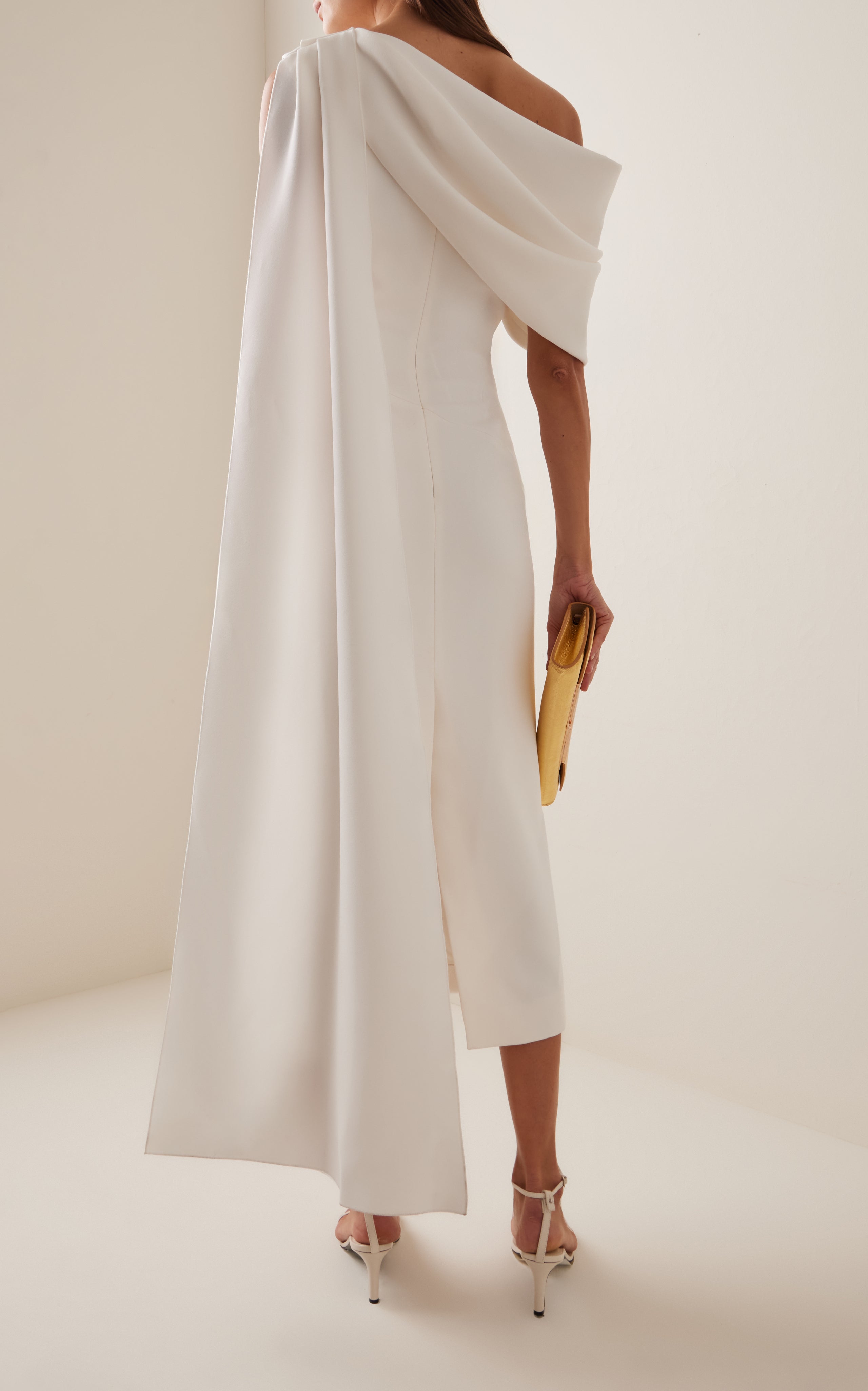 Experience the vibrant and modern aesthetic with the Maite Cape-Detailed Asymmetric Bonded Crepe Midi Dress by Roksanda. This dress features a single-shoulder cape and bold use of color, showcasing the label's expressive and dynamic use of fabrics. With its sculptural and structural design, the 'Maite' is sure to make a statement at any event.