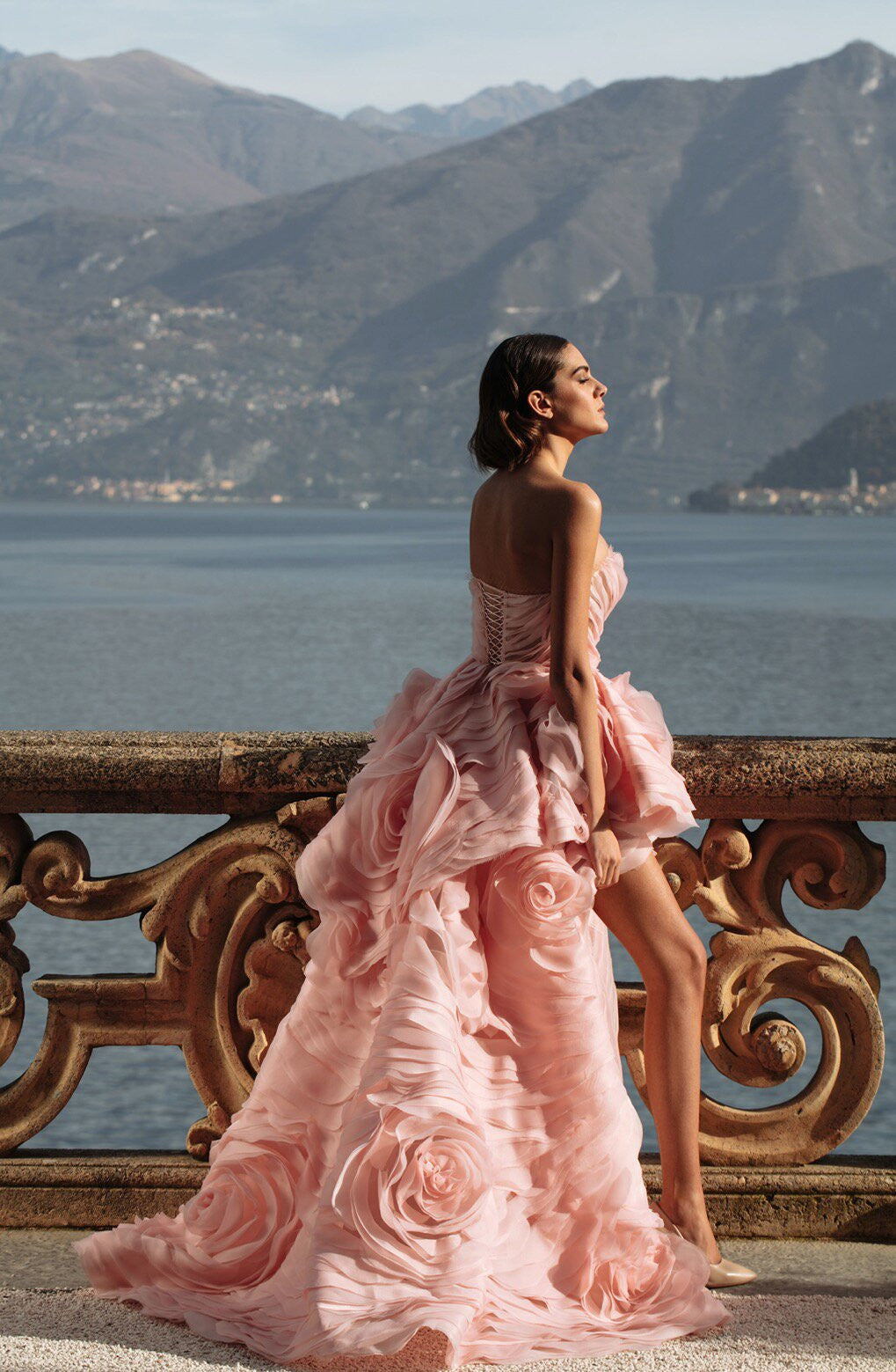 Indulge in luxury with the Rosalind Gown. This exquisite gown boasts a strapless design, adorned with delicate ruffles and rose-like embellishments. Made for the distinguished, the Rosalind Gown exudes elegance and grace. Make a statement at your next event and feel like a true work of art in this stunning gown.