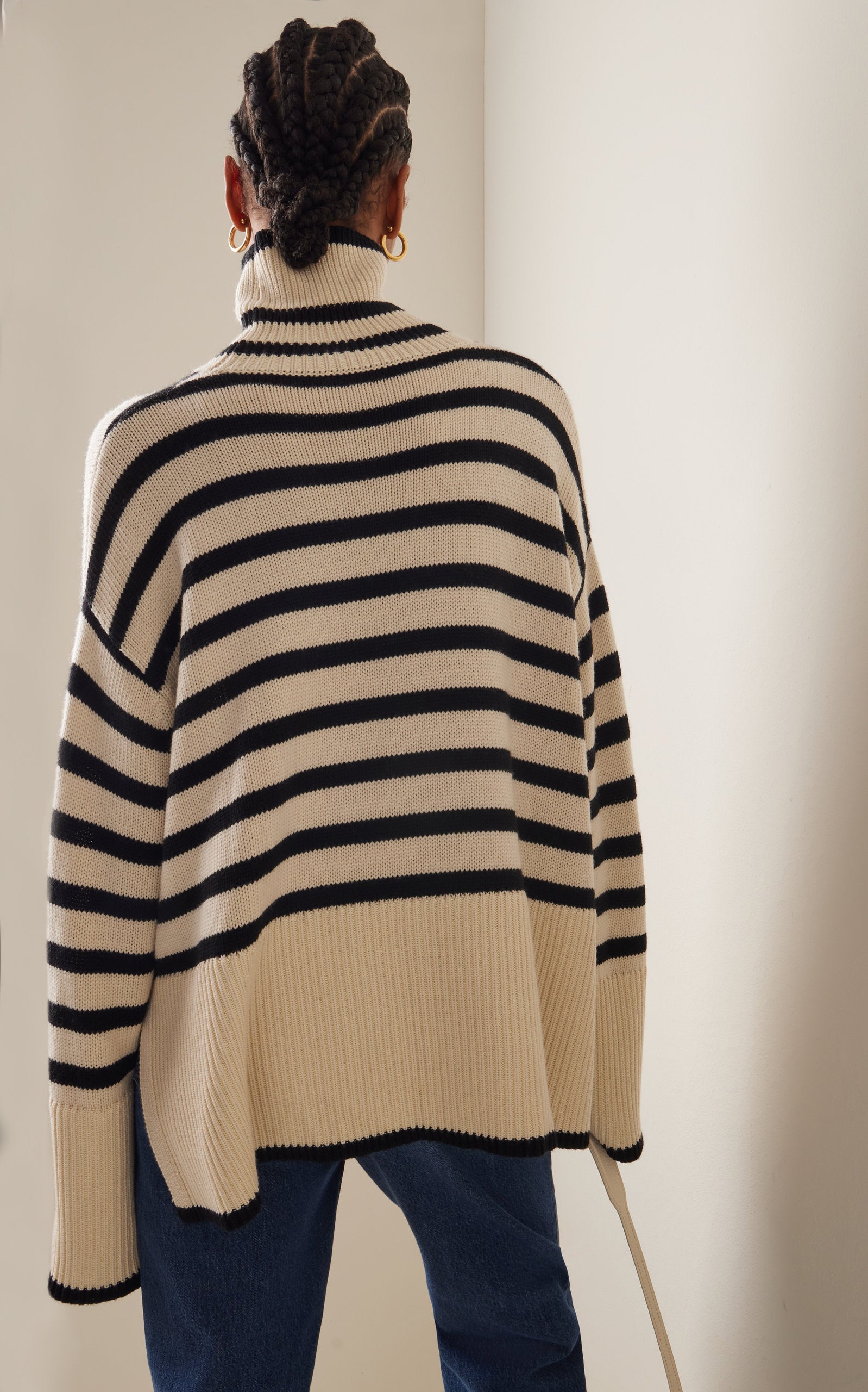 Elevate your wardrobe with the Signature Stripe Wool-Cotton Turtleneck Sweater by Totême. Blending cozy wool and breathable cotton, this sweater offers unmatched comfort and timeless style. Its clean lines and minimalist design reflect Stockholm's refined aesthetic, making it a versatile staple perfect for effortless layering. Inspired by vintage classics, this turtleneck channels modern Scandi-cool, providing a chic, everyday uniform that stands out with subtle sophistication.