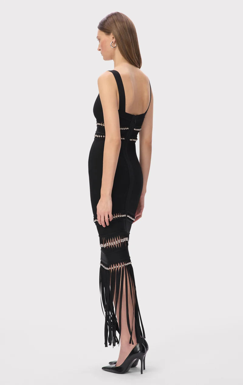 The Ines Gown by Hervé Léger epitomizes modern elegance with its expertly engineered body-contouring midi silhouette designed to enhance your natural curves. The bold square neckline makes an unforgettable statement, while meticulously hand-placed silver beads create a mesmerizing shimmer that captures light with every movement. Strategically positioned cutouts reveal just enough skin to add sophisticated allure, proving that true luxury lies in the perfect balance between coverage and confidence. 