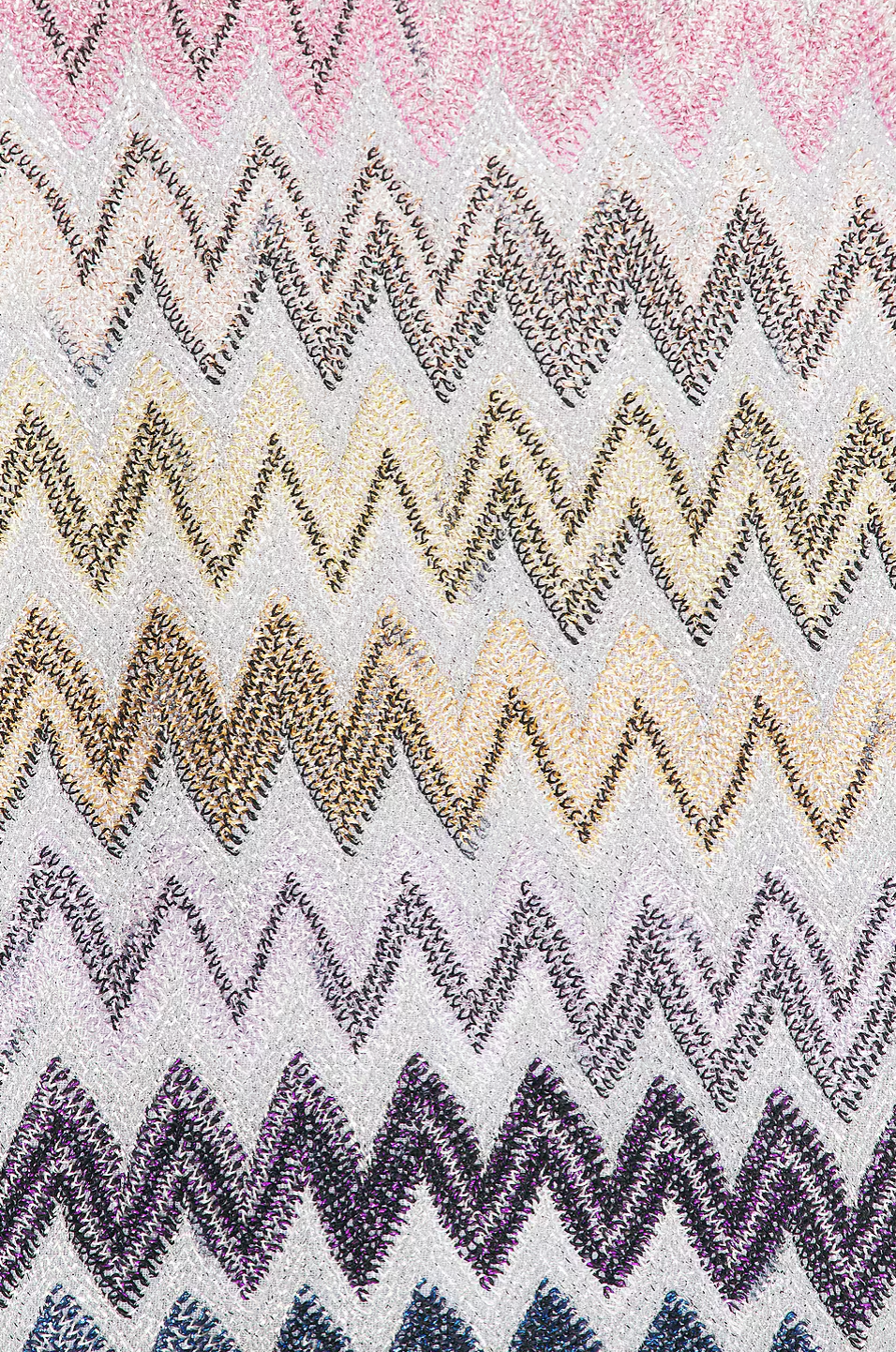 This sleeveless mini dress showcases Missoni’s iconic zig zag pattern, delivering a bold, stylish look. Its short length adds a flirty touch, while the invisible zipper closure ensures a sleek, seamless fit. Perfect for making a statement at any event, this dress combines fashion-forward design with effortless wearability.