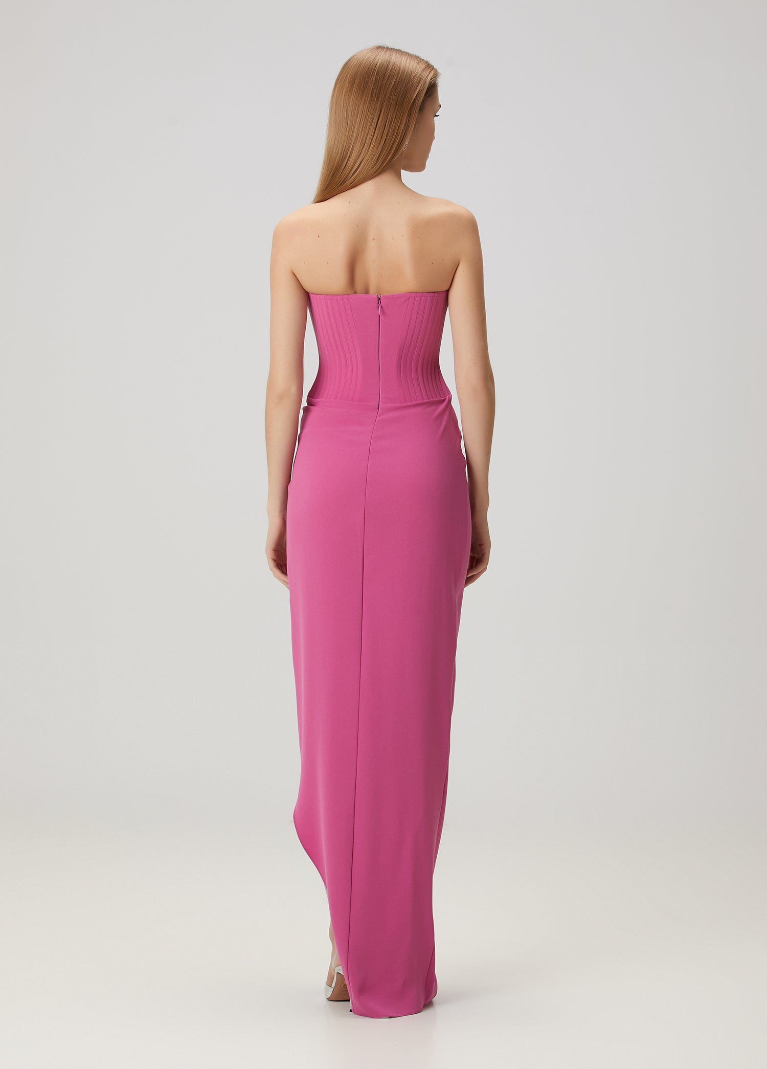 Elevate your evening look with this stunning pink maxi dress by Alex Perry that combines timeless elegance with modern sophistication. The strapless design creates a graceful silhouette, while expertly placed drapes add dimension and movement to every step. A daring thigh-high slit offers a hint of allure without compromising the dress's refined aesthetic. The secure back zipper ensures a flawless fit that lasts all night. 