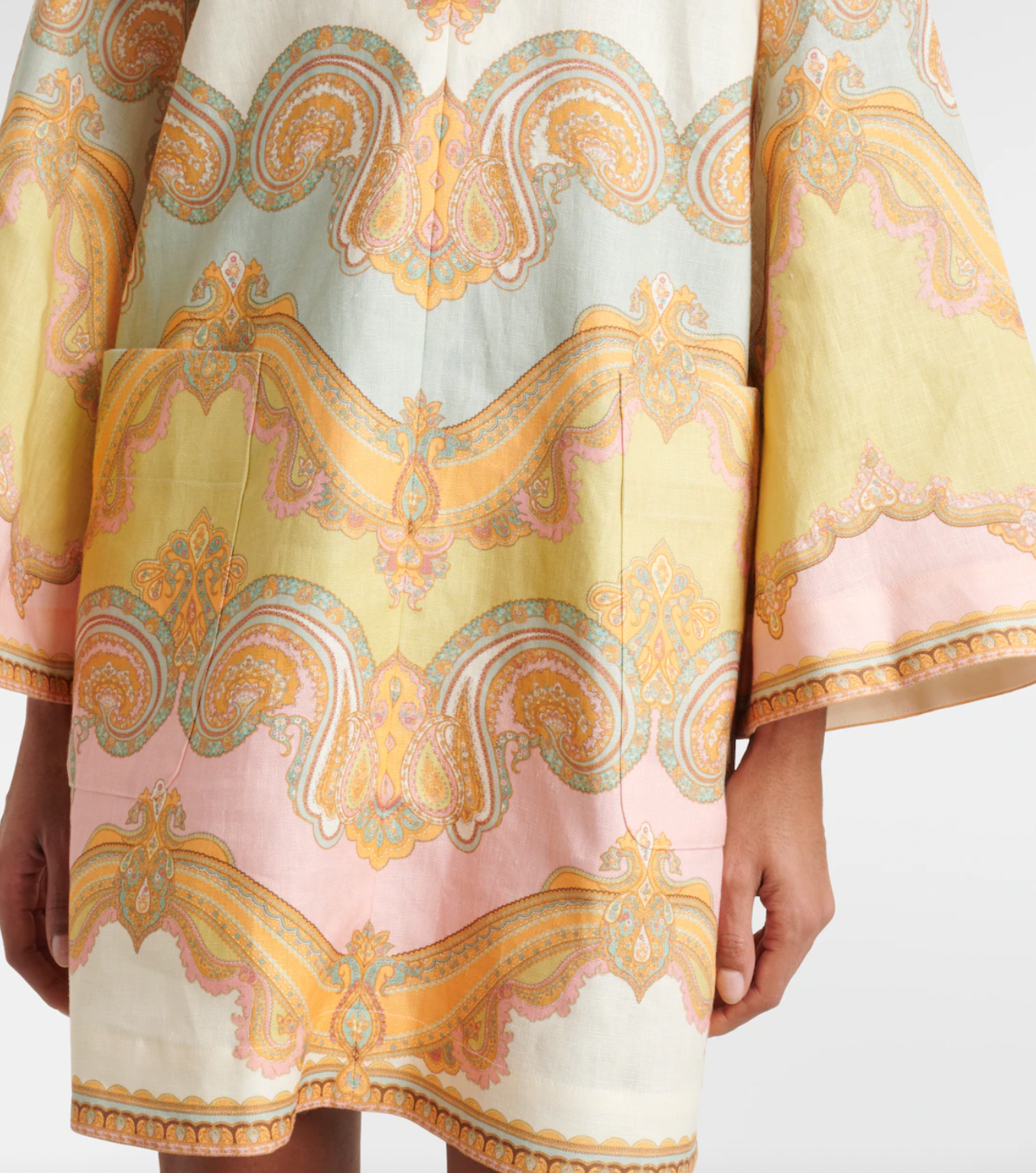 Elevate your resort style with the Maxine paisley linen minidress in Gold Paisley by Zimmermann. Made from breathable linen, this dress combines comfort with elegance, featuring a deep V-neckline and wide sleeves that enhance its chic appeal. Practical patch pockets add convenience, while the center back zip provides a tailored fit. Perfect for relaxed daytime outings or sophisticated evening events, this dress is a versatile addition to your wardrobe.