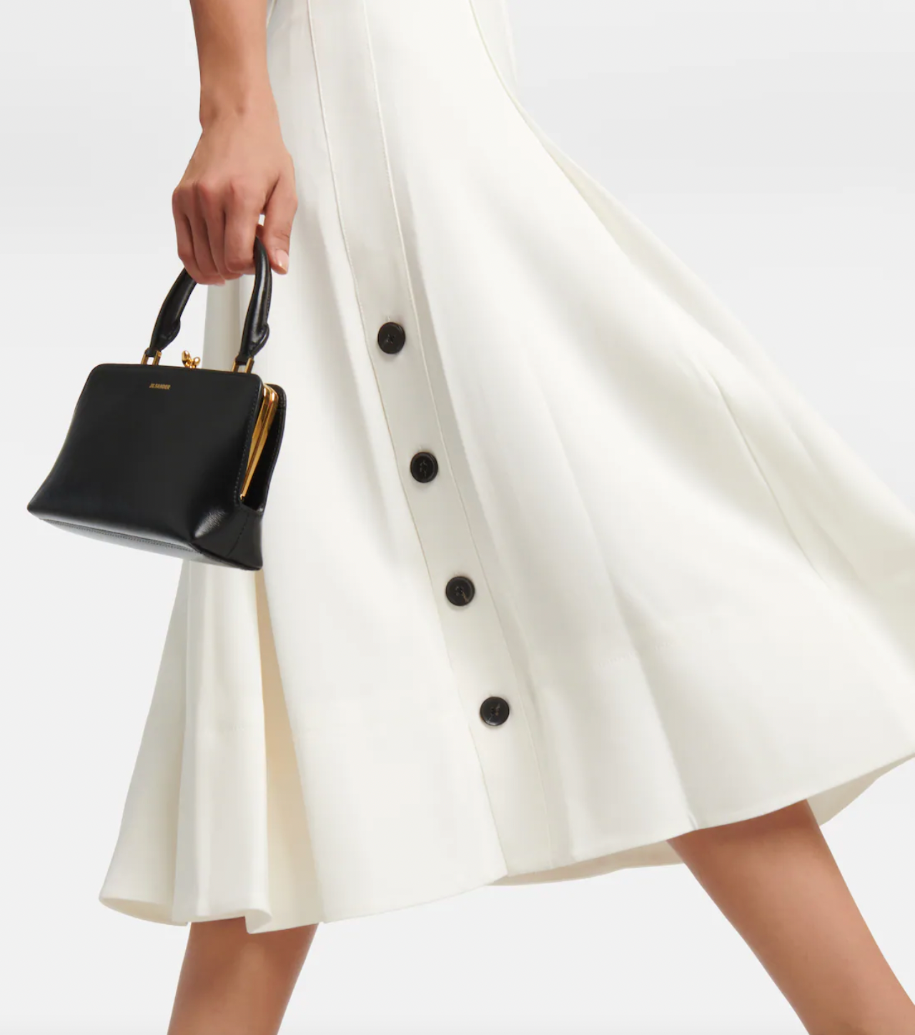 Elevate your wardrobe with this crepe midi dress, inspired by the timeless elegance of Proenza Schouler. Crafted from smooth crepe fabric, it boasts a flattering V-neckline and a fitted bodice that enhances your silhouette. The softly pleated A-line skirt adds gentle movement and grace, making it perfect for both special occasions and refined everyday wear. This dress combines effortless style with sophisticated charm, becoming an essential piece in any chic closet.