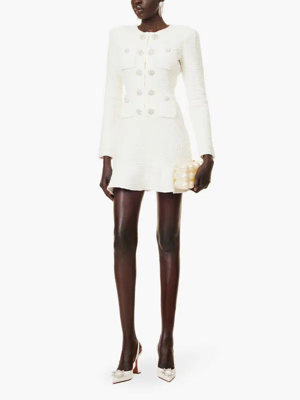 Stay sophisticated and stylish in this Self-Portrait waffle-knit midi dress. With a slim fit and rhinestone buttons, this dress will elevate your look. The boucle texture and sequin embellishment add a touch of glamour, while the braided trims and flared hem add playful details. A must-have for any fashion-forward wardrobe.