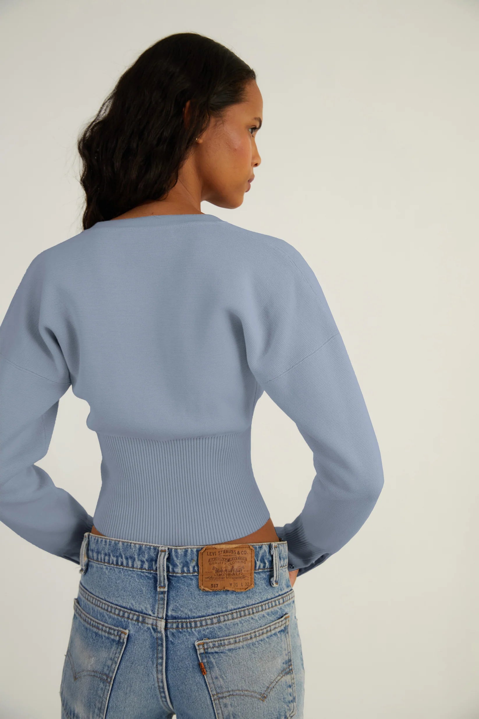 Elevate your style with The Weekend Knit Cardigan by Orseund Iris. Made from a luxurious blend of cotton and silk, this chunky Milano knit cardigan adds volume at the shoulders and cinches at the waist for a flattering silhouette. With its long and dramatic sleeves, it's the perfect addition to your wardrobe for a touch of sophisticated elegance.