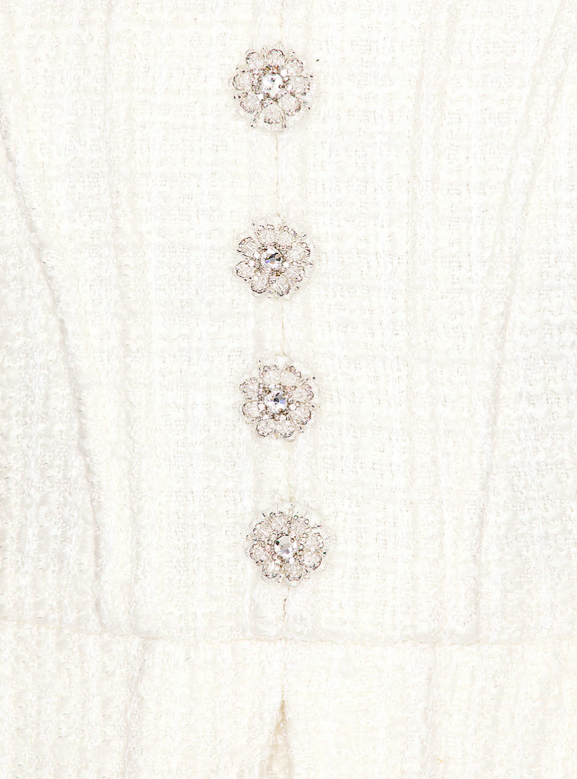 Showcase your trendy style with the fully lined Boucle Peplum Mini Dress by Self-Portrait. Sleek and sophisticated, this dress features a hidden back zipper closure and a boned bodice adorned with crystal-embellished front buttons. The tweed fabric with metallic threading adds a touch of glamour, while the draped peplum accentuates your silhouette. A must-have for any fashion-forward wardrobe!