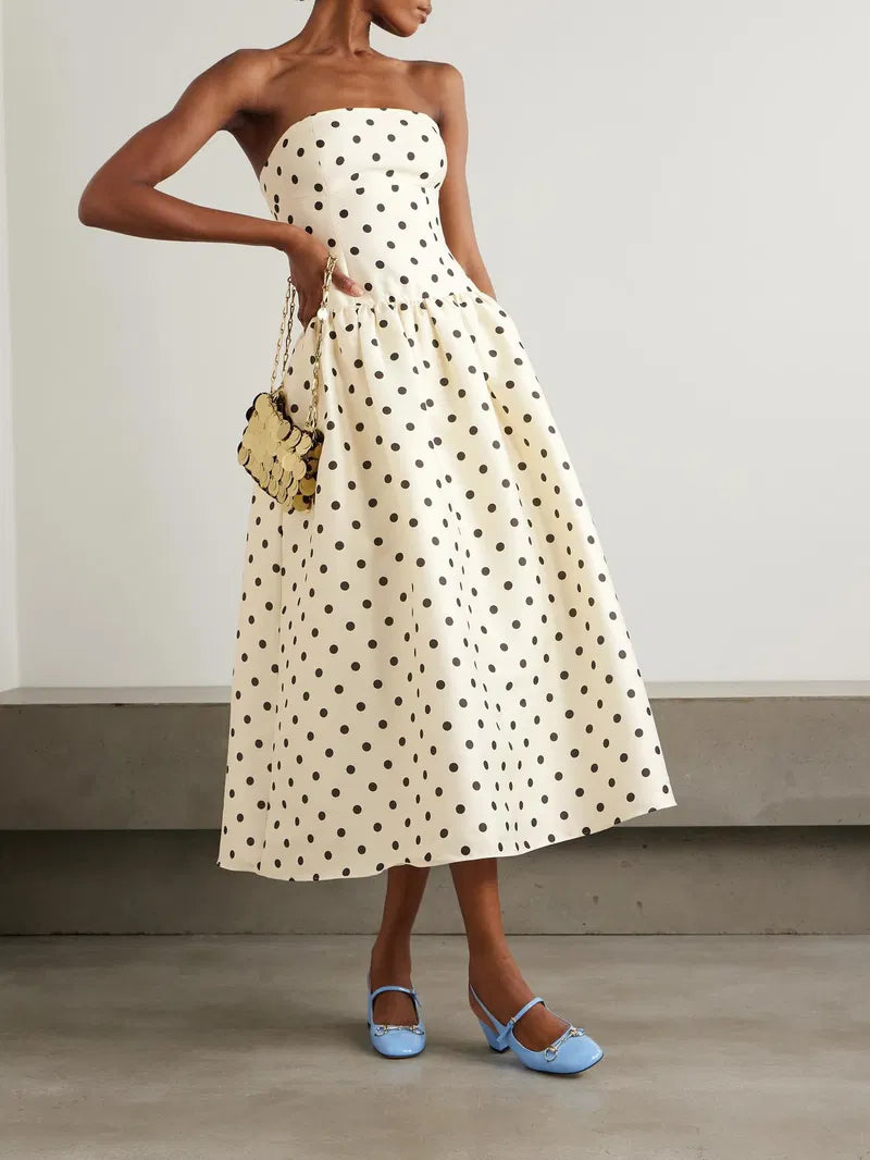 Embrace timeless elegance with this Polka-dot taffeta midi dress inspired by classic 1950s fashion. The luxurious taffeta fabric shines subtly, while the structured bodice and gathered waist beautifully highlight a full, flattering skirt. Perfect for making a graceful statement, pair it with point-toe pumps to complete your vintage-chic look.