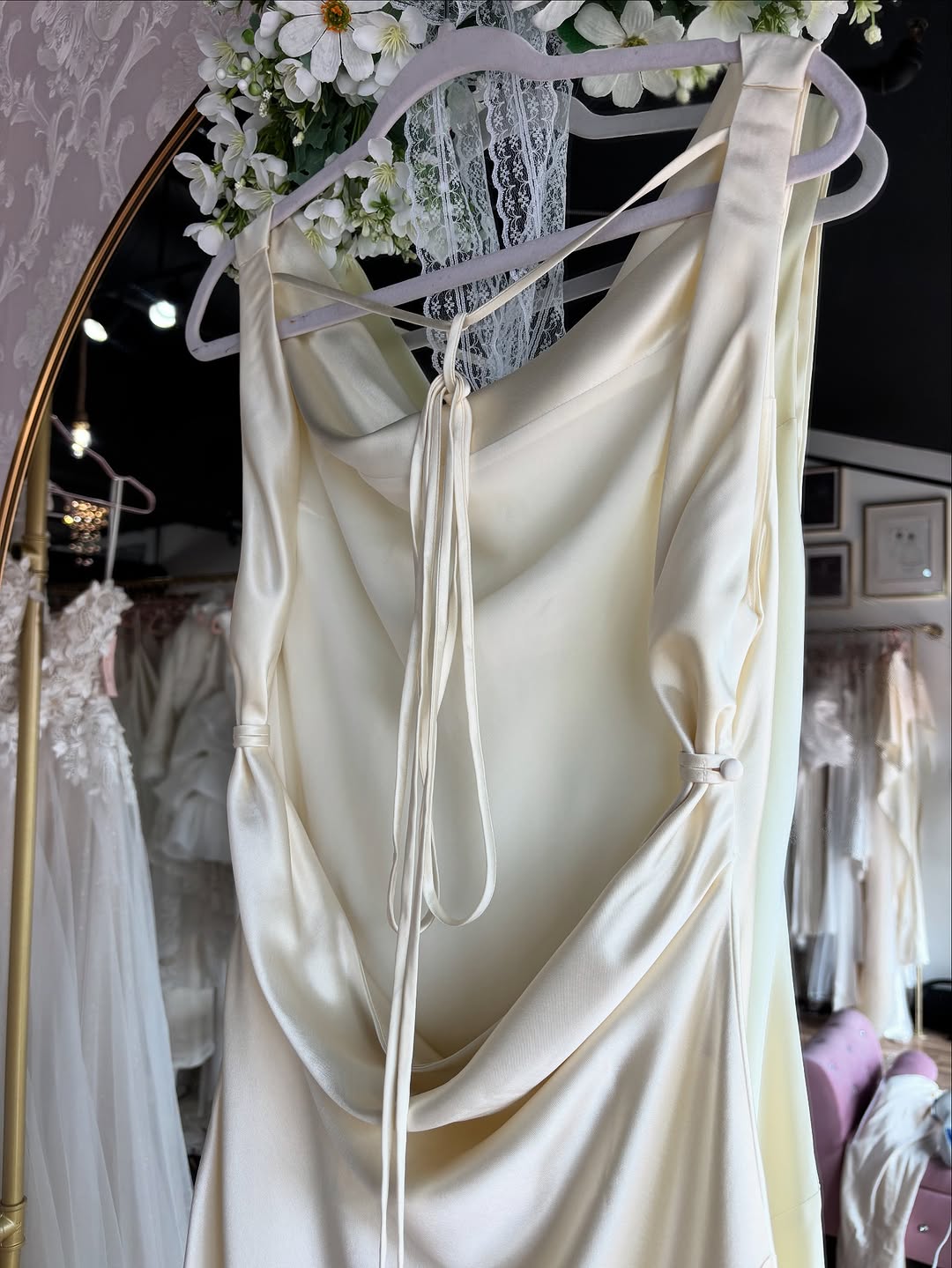 The Jeany Silk Dress delights with adjustable straps and a chic halter neckline, perfectly complemented by elegant back buttons and bias stitching that beautifully drapes your silhouette. Designed to flirt with the floor when paired with heels, it offers a stunningly elongated look—just the right excuse for a little hemming fun! The playful ties at the back ensure a fit as unique as you are, combining charm and comfort for those unforgettable special moments.