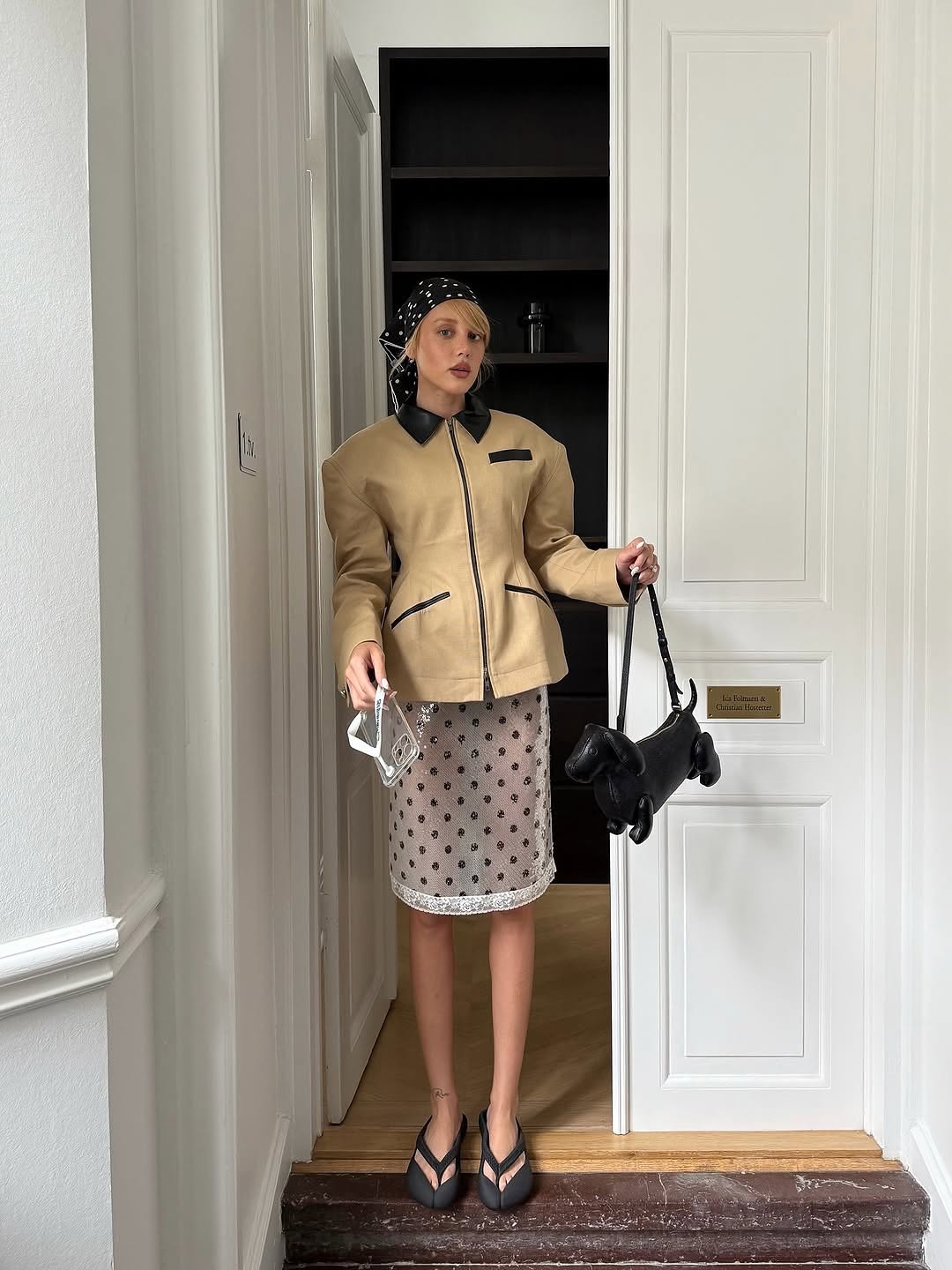 Hourglass Canvas Jacket Master the art of effortless sophistication with this canvas work jacket that refuses to compromise on style. The sculpted hourglass silhouette flatters your frame while bold padded shoulders project quiet confidence. A striking leather collar elevates the everyday, transforming a utilitarian piece into a statement. Adjustable buttoned tabs at the back give you complete control over your fit—customize it to perfection.