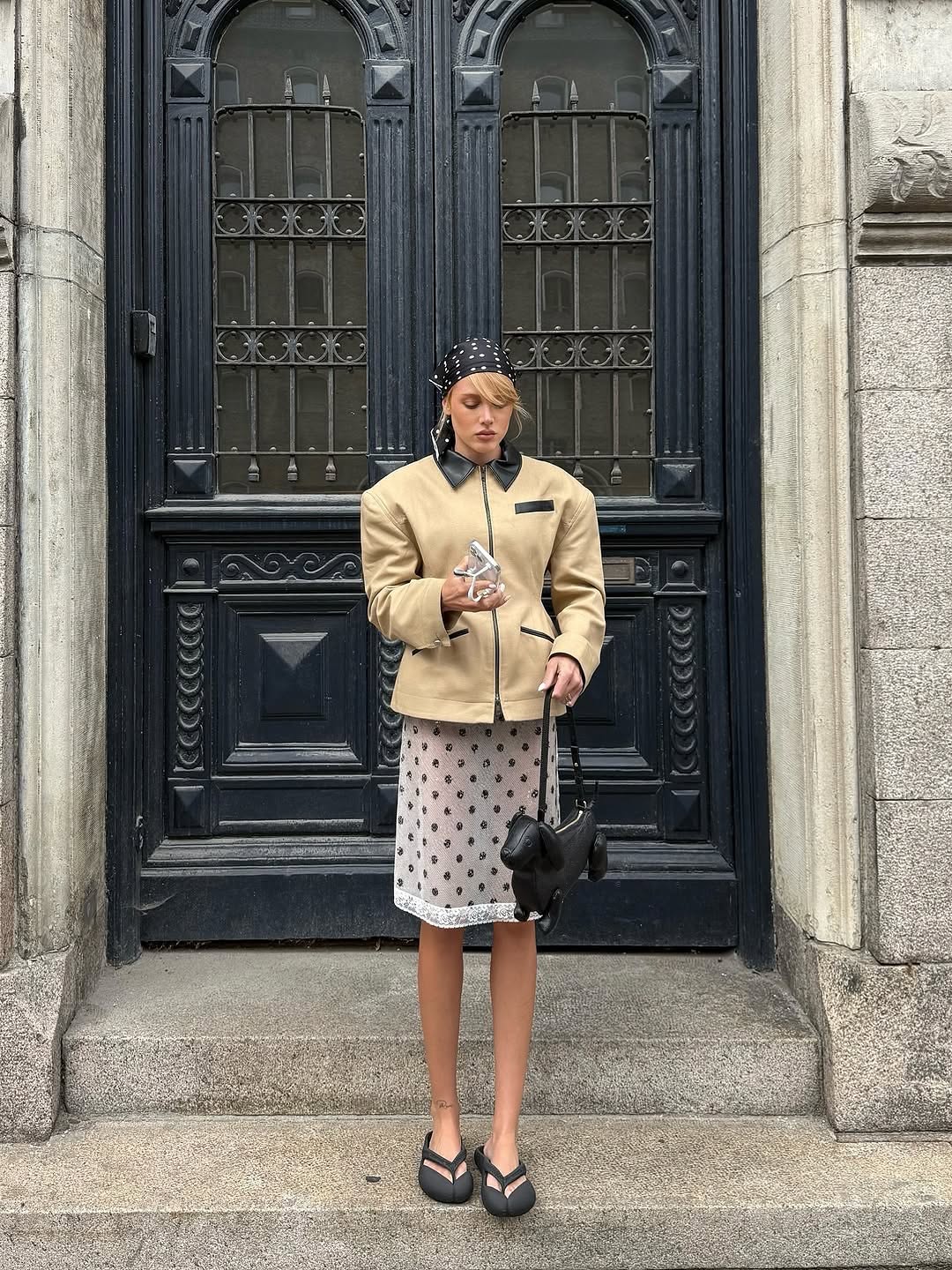 Hourglass Canvas Jacket Master the art of effortless sophistication with this canvas work jacket that refuses to compromise on style. The sculpted hourglass silhouette flatters your frame while bold padded shoulders project quiet confidence. A striking leather collar elevates the everyday, transforming a utilitarian piece into a statement. Adjustable buttoned tabs at the back give you complete control over your fit—customize it to perfection.