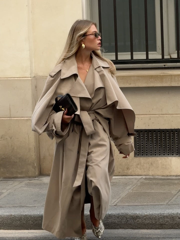 This Caped Trench Coat redefines elegance by combining classic tailoring with dramatic cape-like details flowing from the shoulders and sleeves. Fully lined for smooth comfort, it delivers a commanding presence while ensuring all-day wearability. Perfect for making a bold statement, this coat adds refined sophistication to your wardrobe.