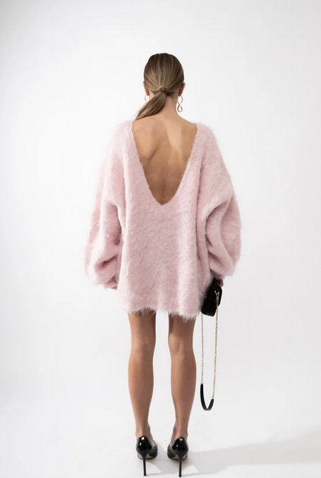 The Gemini Sweater Dress is not just another sweater dress. It's a statement piece that combines comfort and style. Made of a soft and fluffy material, it features a deep V-neck in the back for a touch of allure. Its loose fit adds a relaxed yet elegant touch to any outfit.