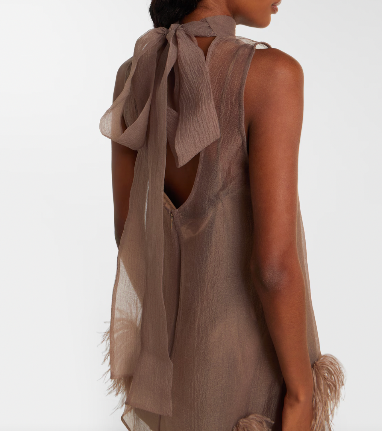 The Albee Feather-trimmed Minidress by Staud is your ticket to turning heads at any upscale occasion. This semi-sheer design combines sophistication with undeniable allure, featuring a flattering high neckline that frames the face beautifully. Luxurious feather trims add an unexpected glamorous edge, elevating the piece from elegant to extraordinary. 