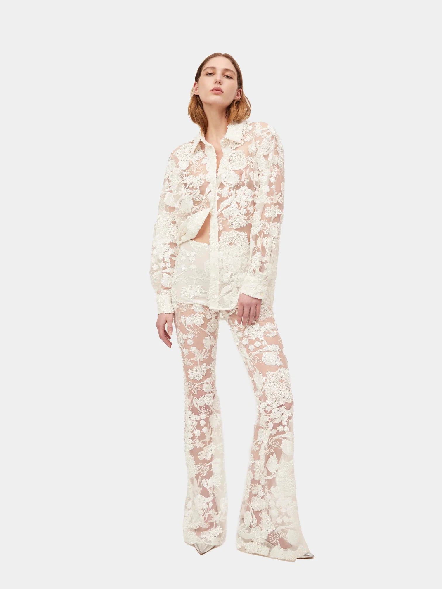 Introducing the Cara Set, a button-up style shirt crafted from exquisite sequin embroidered tulle, designed exclusively by AKNVAS. Elevate your wardrobe with this luxurious piece that combines sophistication and artistry. Perfect for any occasion, this shirt exudes style and exclusivity.