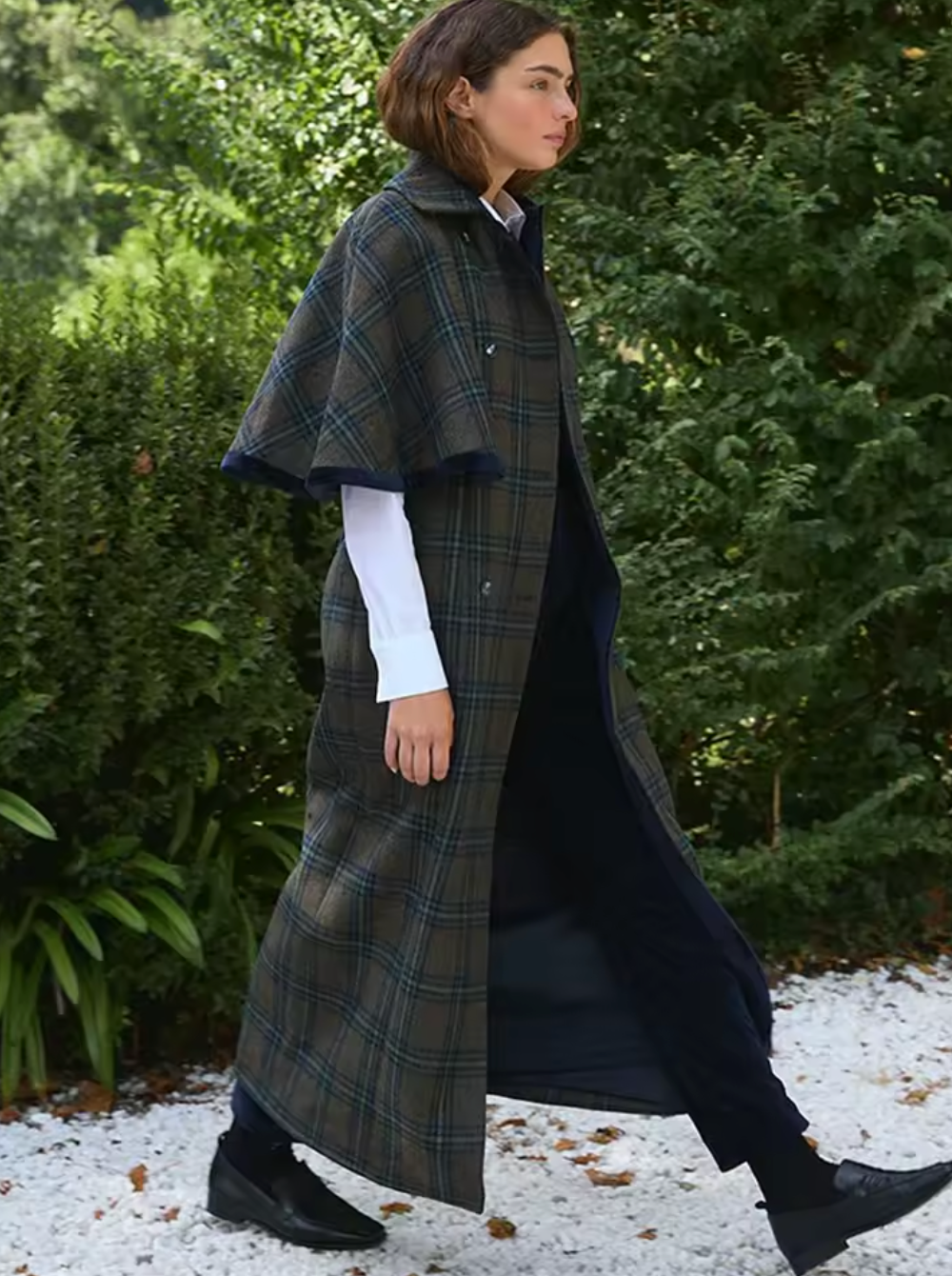 Experience timeless elegance with the Brynne Coat, crafted from a cozy wool blend for warmth and durability. Its maxi trench style features a stylish cape overlay, creating a relaxed fit that layers effortlessly over your favorite outfits. Designed to keep you comfortable on crisp autumn days, this coat blends vintage charm with contemporary flair, making it an indispensable piece for elevating your wardrobe with sophistication and comfort.