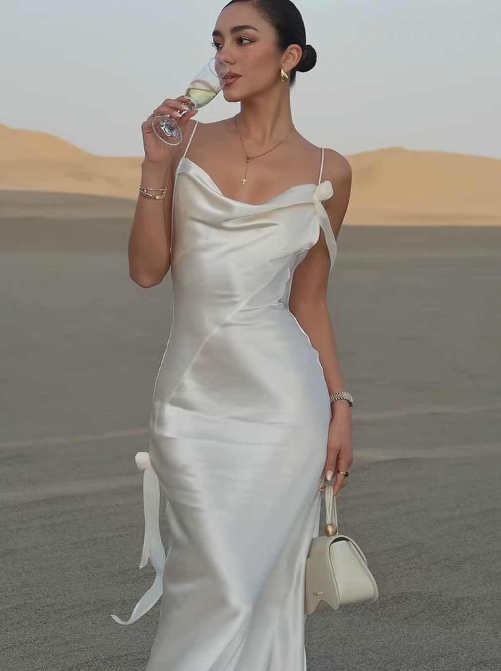 Indulge in effortless elegance with the Lorella Maxi Dress. The lustrous satin fabric is cut on a bias for a flattering fit, while the cowl neck, chic shoulder detail, and deep back drape add a touch of sophistication. The straps can be tailored for a perfect fit, making it the ideal choice for any event.
