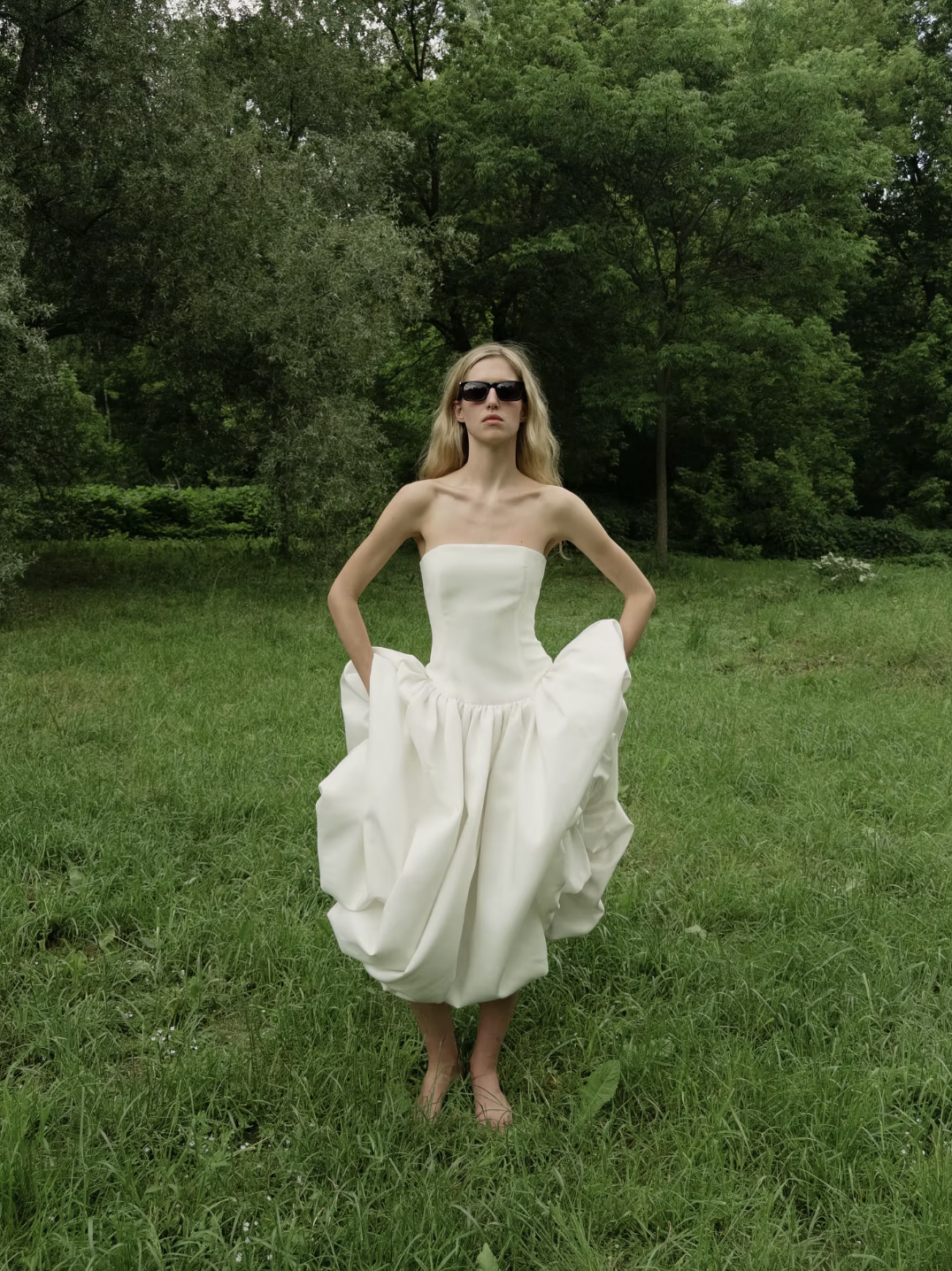 The Mayfair Dress offers timeless sophistication with a modern twist. Featuring a strapless, solid bodice and a flattering A-line silhouette, it highlights your figure with a high waist and pleated skirt that flows elegantly. Perfect for summer events and upscale parties, this sleeveless dress ensures comfort while exuding effortless grace, making it the ideal choice for warm-weather style.