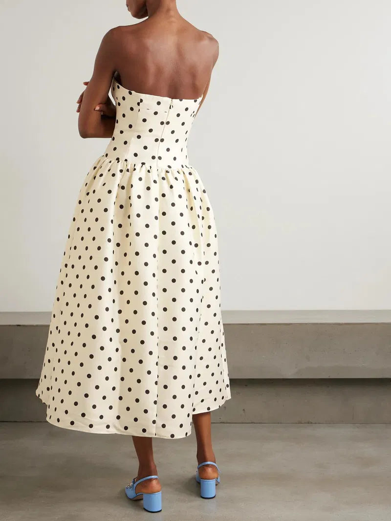 Embrace timeless elegance with this Polka-dot taffeta midi dress inspired by classic 1950s fashion. The luxurious taffeta fabric shines subtly, while the structured bodice and gathered waist beautifully highlight a full, flattering skirt. Perfect for making a graceful statement, pair it with point-toe pumps to complete your vintage-chic look.