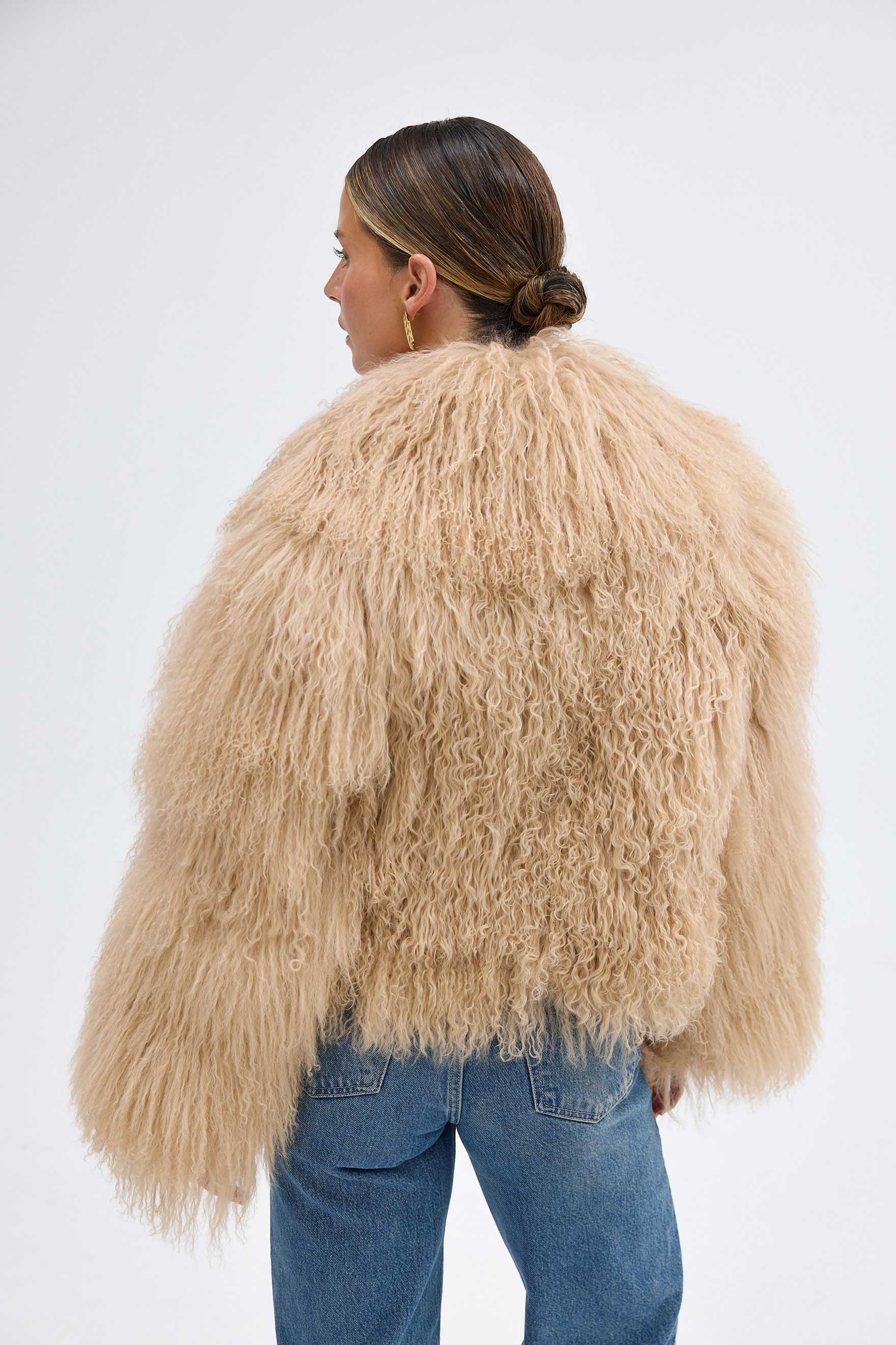 The Georgina Jacket combines timeless style with bold attitude, crafted from 100% luxurious Mongolian lamb fur. Its sleek design features concealed fastenings for a clean, sophisticated look. Perfect for making a statement, this jacket offers both elegance and warmth for any occasion.