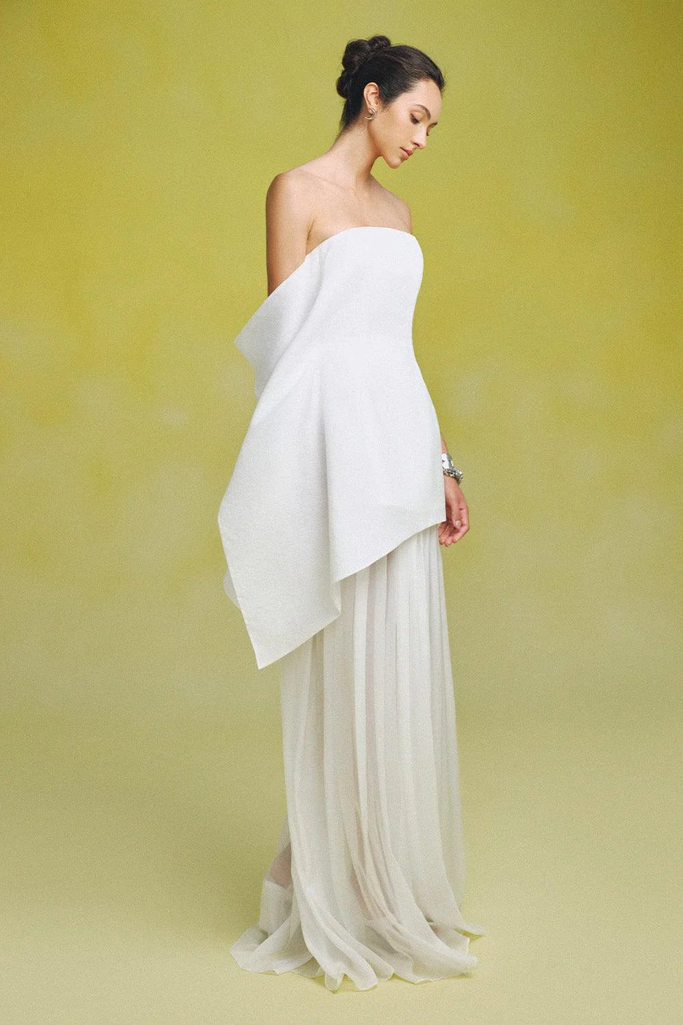 Indulge in luxury with our Gina Silk Maxi Dress. Made from premium silk chiffon, this strapless dress features elegant gatherings for a flattering and sophisticated fit. Perfect for special occasions, elevate your style with this stunning and exclusive piece.