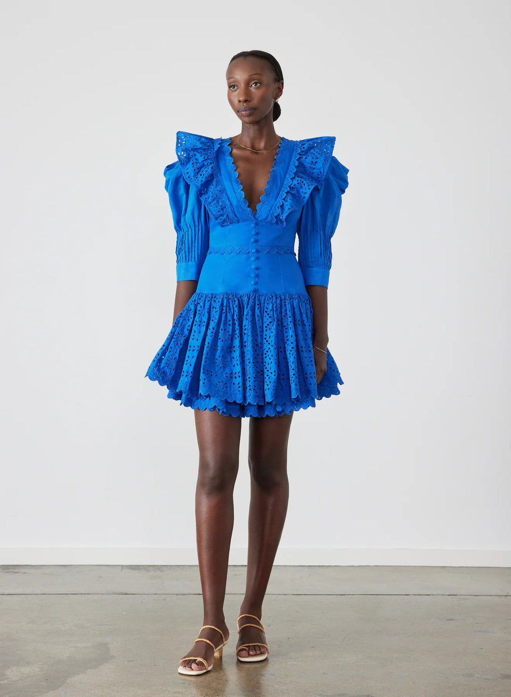 Elevate your style with Viktoria Broderie Mini Dress by Joslin. This certified organic cotton poplin dress embraces timeless charm and modern sophistication, perfect for the contemporary woman. Featuring a modest plunge neckline, contrast cotton broderie details, and stunning structured cotton organdy mutton sleeves, Viktoria exudes classic elegance with a touch of allure.