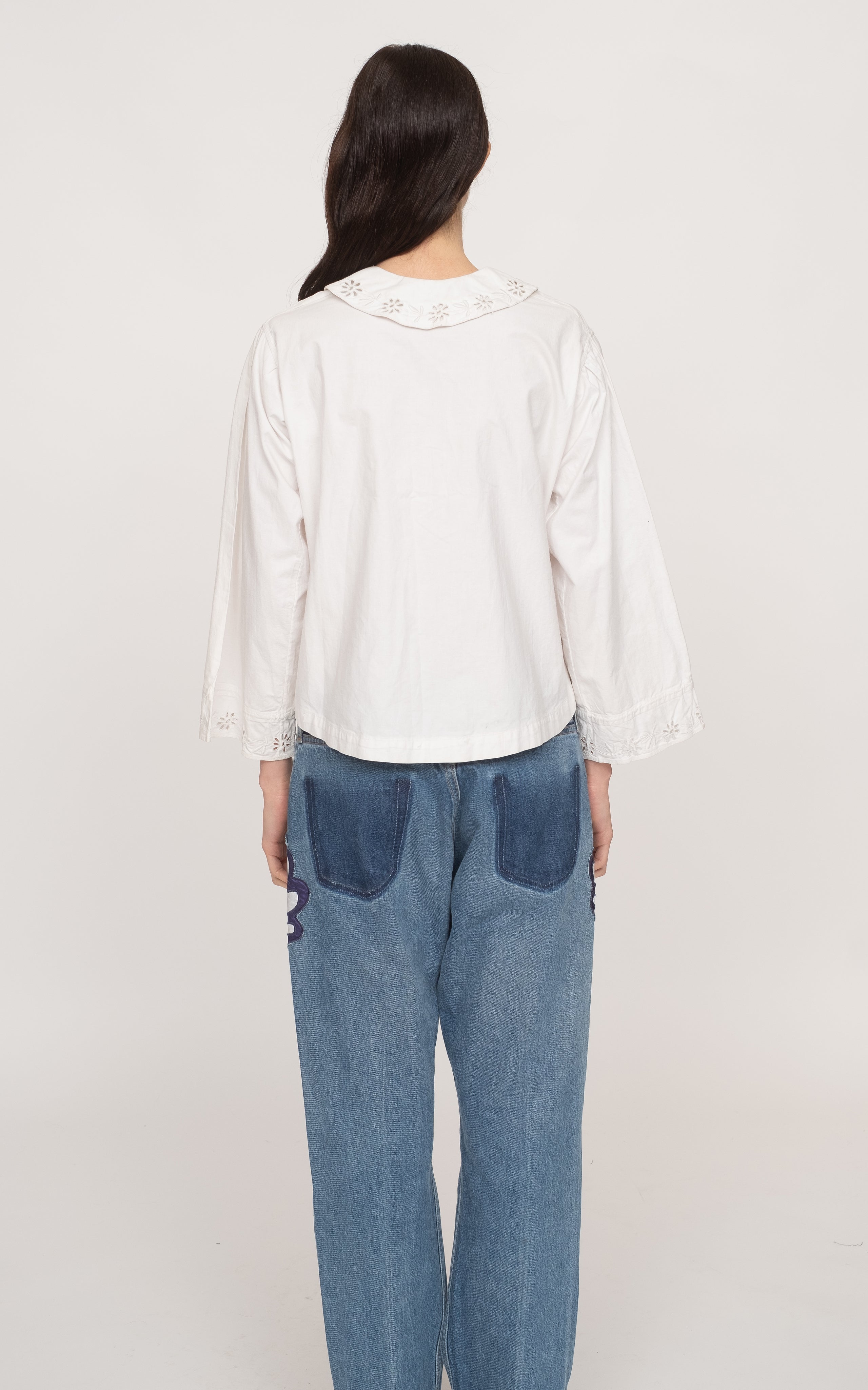 Get ready to rock the fashion world with the Paloma Eyelet Top! This collared top features a relaxed fit and is made with 100% cotton for ultimate comfort. Unlined for a breezy feel, it comes in a classic white color and has a button and zip fastening. Perfect for a casual yet chic look!