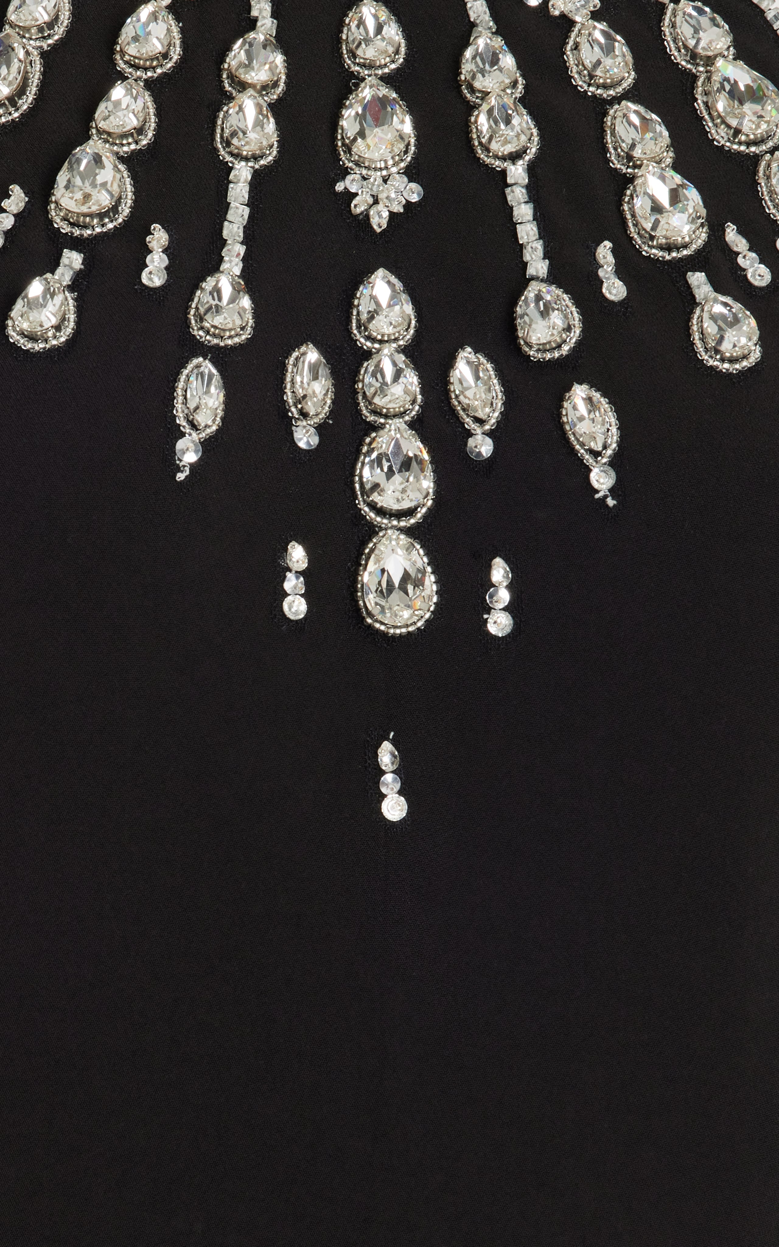 Make a statement in the Crystal-Embellished Cady Halter Maxi Dress by Zuhair Murad! Crafted from luxurious cady fabric, this halter gown boasts a slim, figure-flattering silhouette. The beautiful teardrop crystal embellishments add a touch of elegance and glamour to any evening occasion. Complete the look with a stunning crystal clutch for a truly showstopping ensemble.