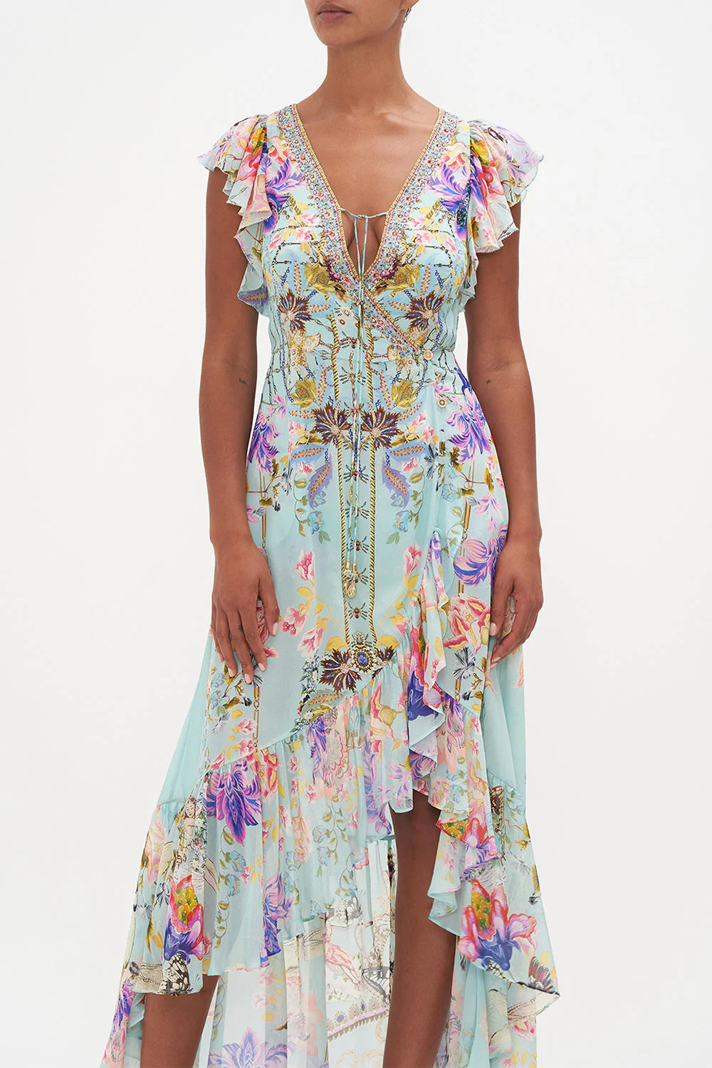 Indulge in elegance with our Love Web Ruffle Wrap Dress by Camilla, inspired by the artistry and femininity. Handcrafted from luxurious silk, this dress features a high-low ruffle hemline and waist-cinching wrap silhouette. Complete with crystal embellishments and neck ties.