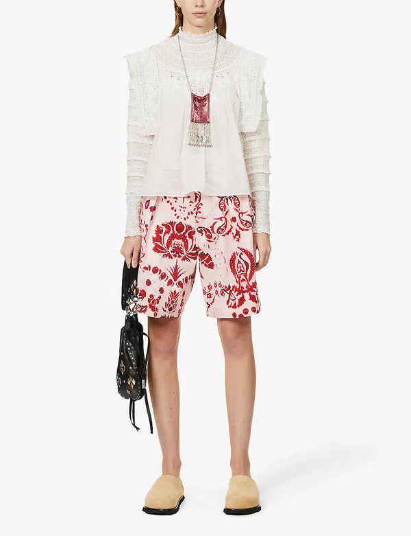 Upgrade your wardrobe with your new favorite top - the Giulia Ruffled Embroidered Cotton-Blend Blouse! Crafted from a luxurious cotton and silk blend, this blouse features delicate broderie anglaise details at the neckline and charming ruffle trim. Each wear will bring a touch of whimsy and romance to your day.