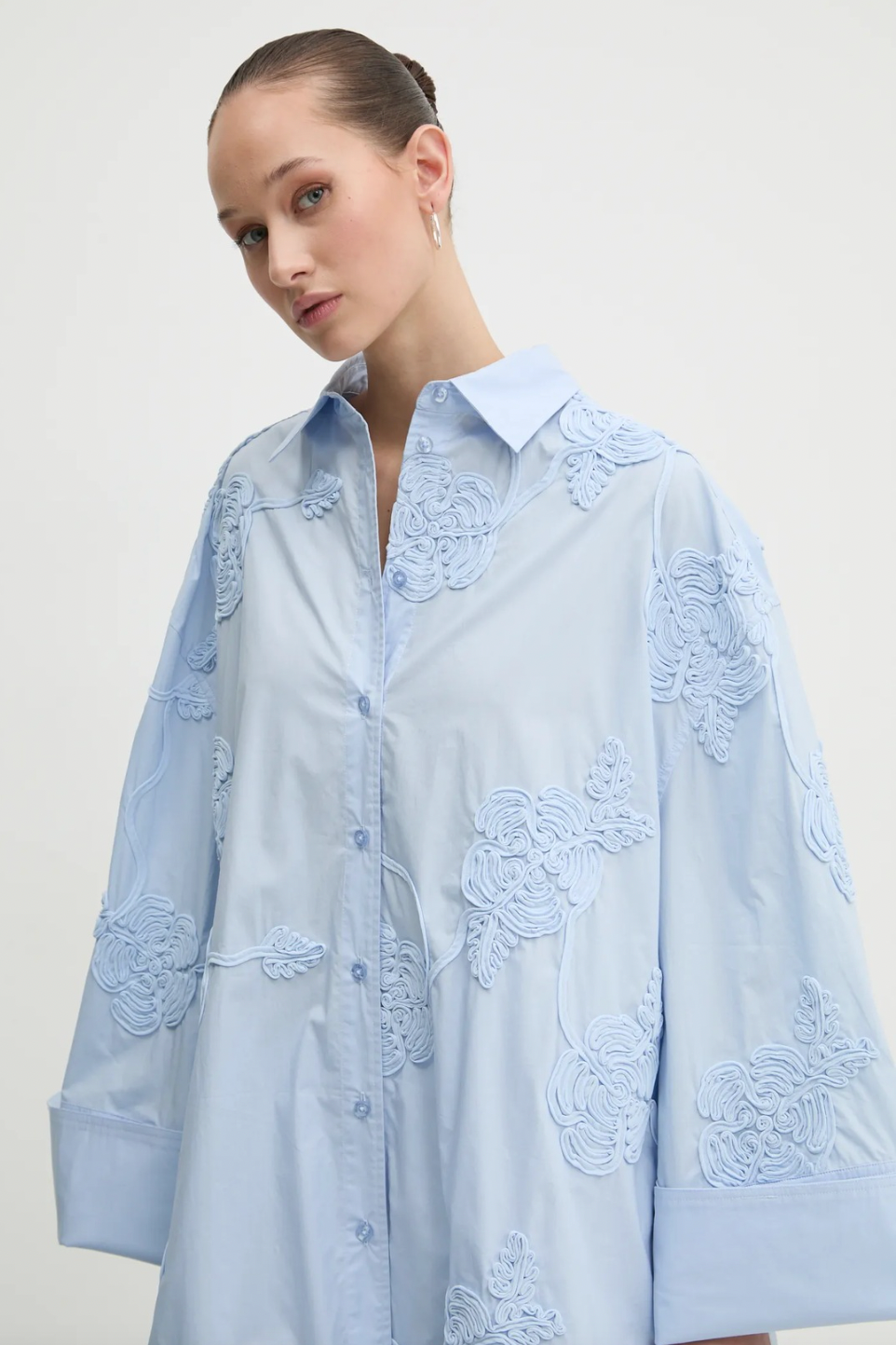 Elevate your style with this high-waisted maxi skirt crafted from sustainable organic cotton. Its flowing, flared design moves gracefully, enhanced by delicate tonal floral embroidery that adds elegant texture. With carefully tailored gathering at the waistband and a hidden side zipper, it offers a flattering fit and lasting comfort. Ideal for sophisticated events, this skirt combines refined elegance with eco-conscious craftsmanship to enhance your wardrobe effortlessly.