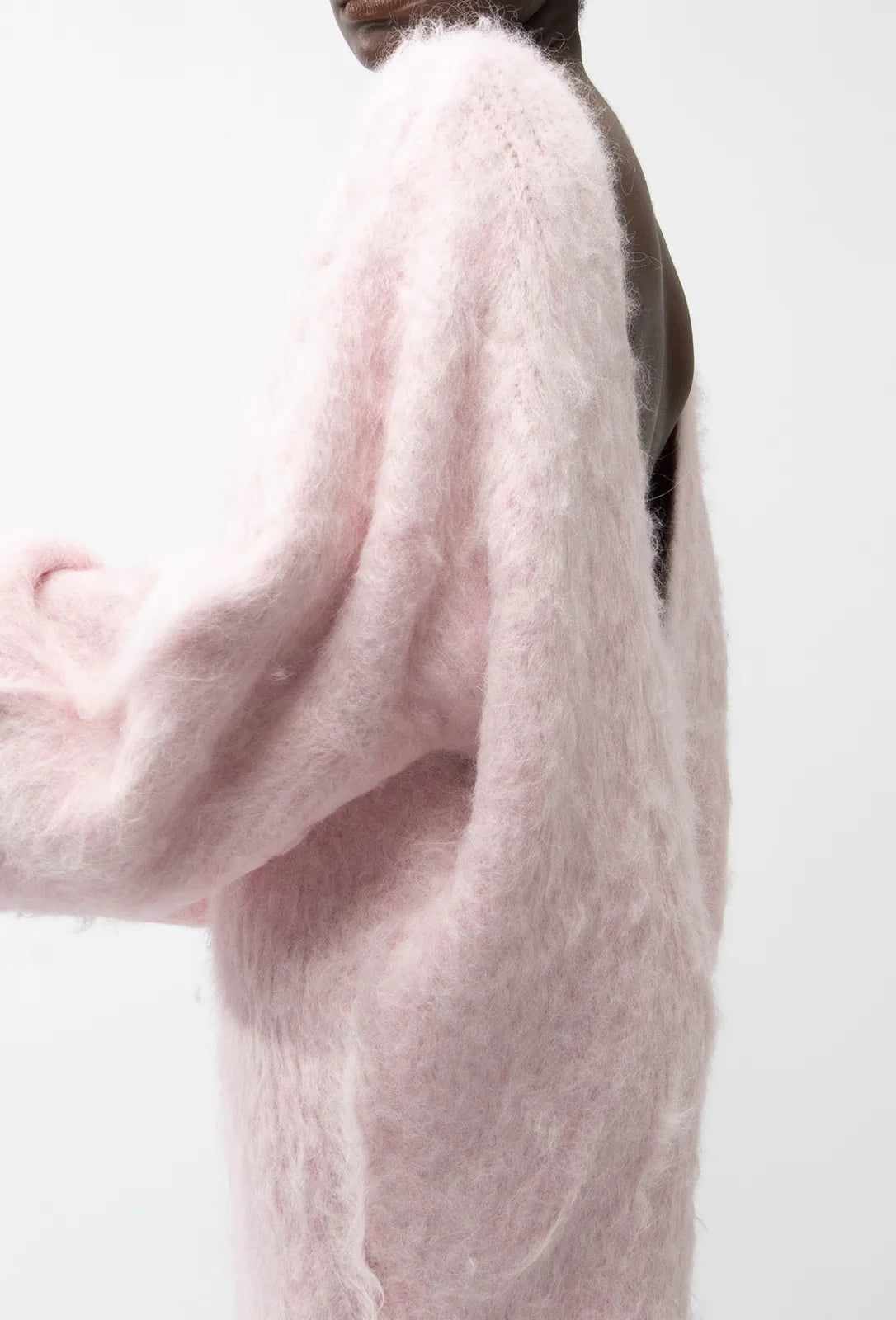 The Gemini Sweater Dress is not just another sweater dress. It's a statement piece that combines comfort and style. Made of a soft and fluffy material, it features a deep V-neck in the back for a touch of allure. Its loose fit adds a relaxed yet elegant touch to any outfit.