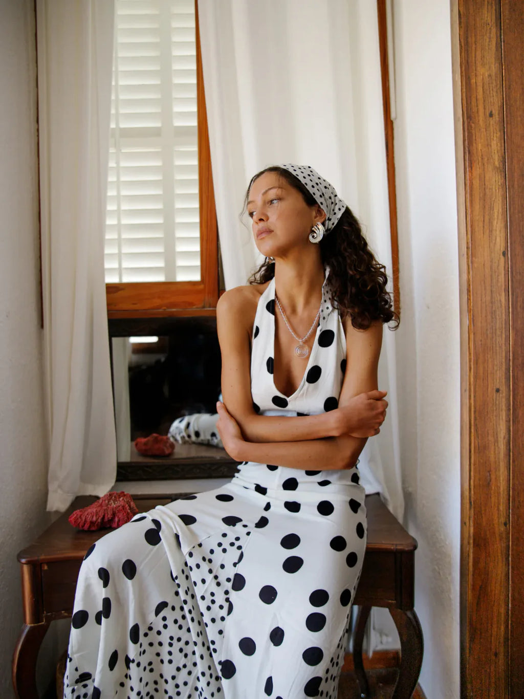 Embrace summer elegance with the Maria Dress, a sleeveless halter maxi featuring a playful dot print and lace-up back for a stunning, backless look. Perfect for vacations or warm evenings, its flowing fabric ensures comfort and style while turning heads wherever you go. Make every moment memorable in this effortlessly graceful dress.