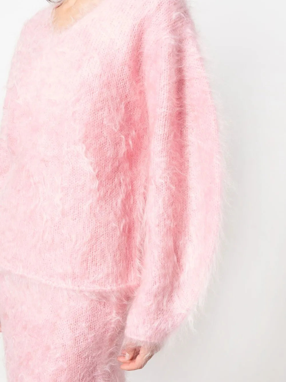 Experience luxurious comfort and style with the BY MALENE BIRGER Merino Wool Blend Set. The Hamie V-Neck Oversize Sweater boasts a cozy Mohair and Merino Wool blend in a feminine Bubble Pink color. Elevate your wardrobe and feel your best with this irresistible combination of quality and fashion.