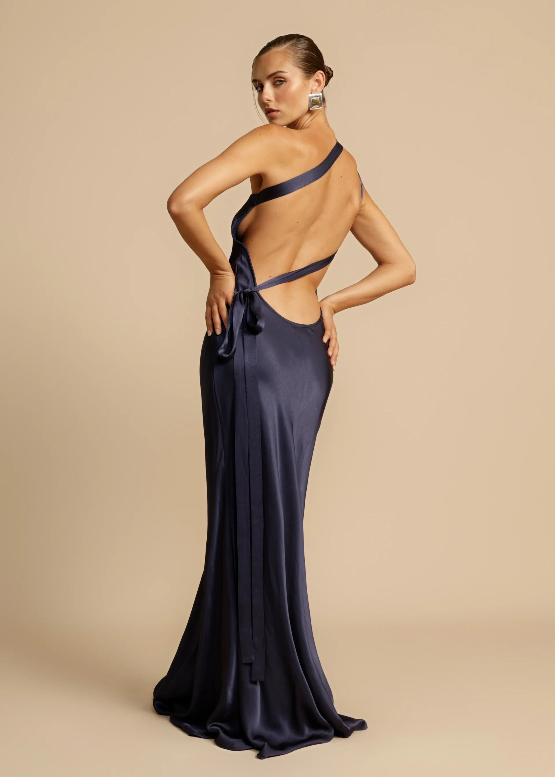Unleash your inner diva with Monique, a stunning floor-length gown that exudes modern elegance. Crafted from luxurious viscose to enhance your curves, Monique's one-shoulder design, open back, and crossover detailing exude sophistication. Whether it's a starlit night or a glamorous event, Monique is the perfect choice for making a lasting impression.